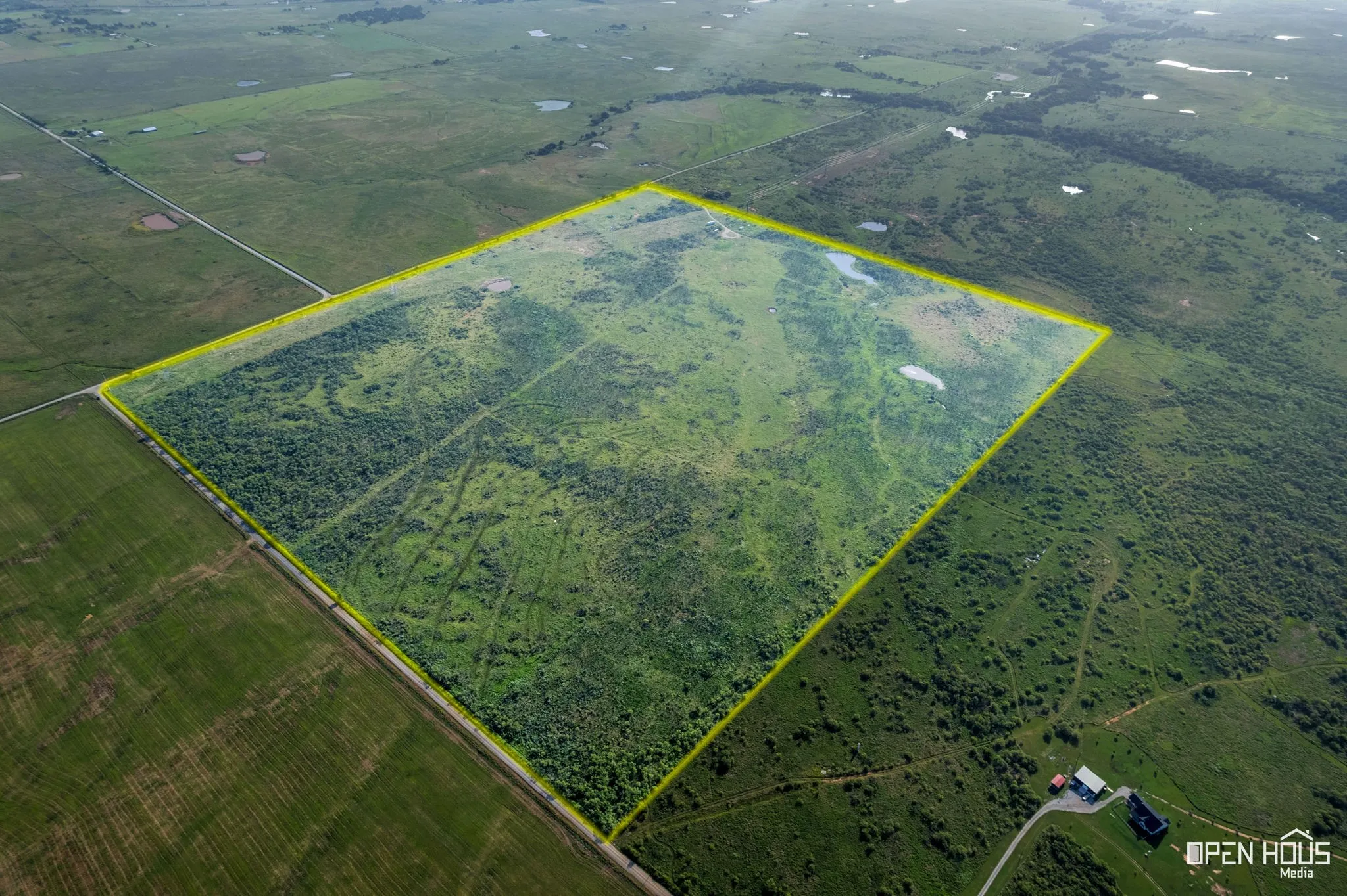 Aerial view of sparsely populated area with property boundaries highlighted