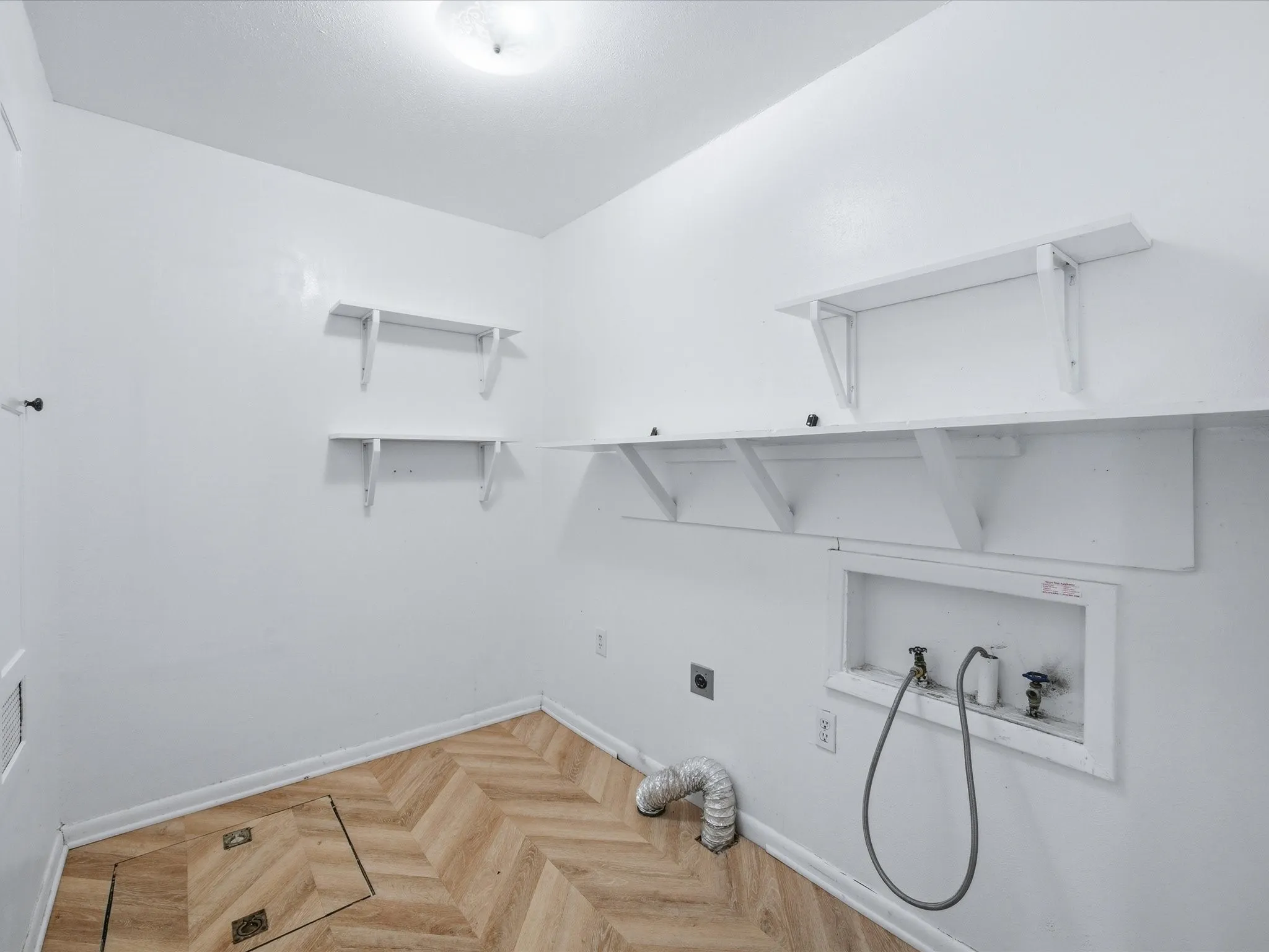 Laundry area featuring hookup for an electric dryer, parquet floors, and hookup for a washing machine