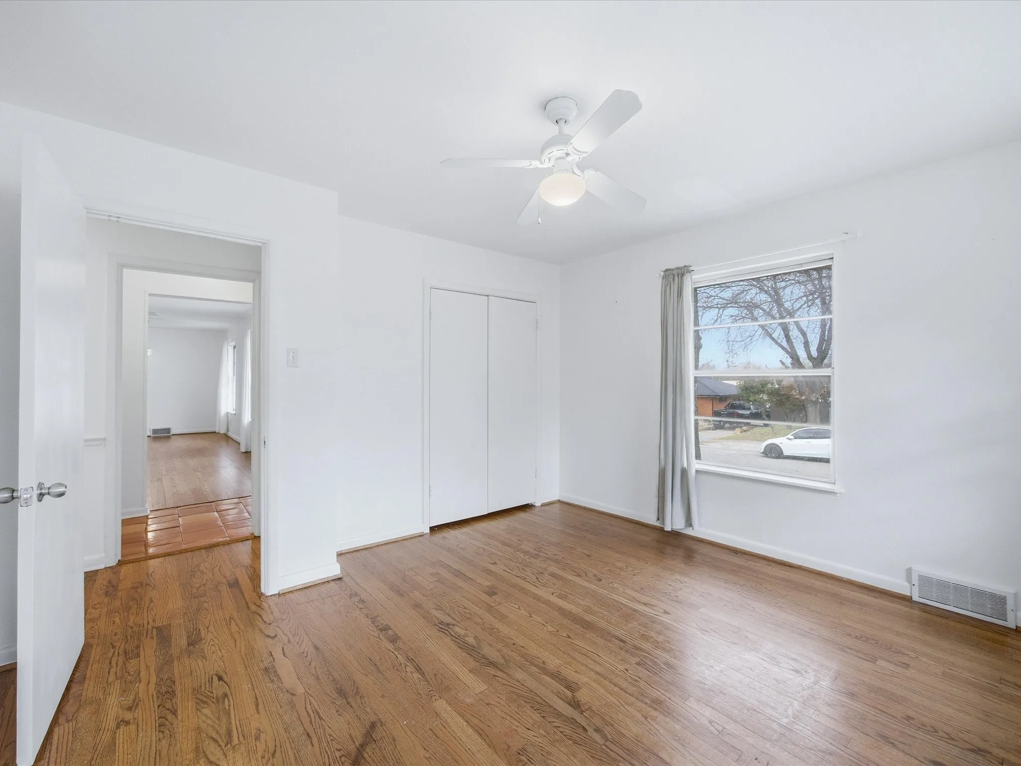 Unfurnished bedroom with wood finished floors, ceiling fan, and a closet