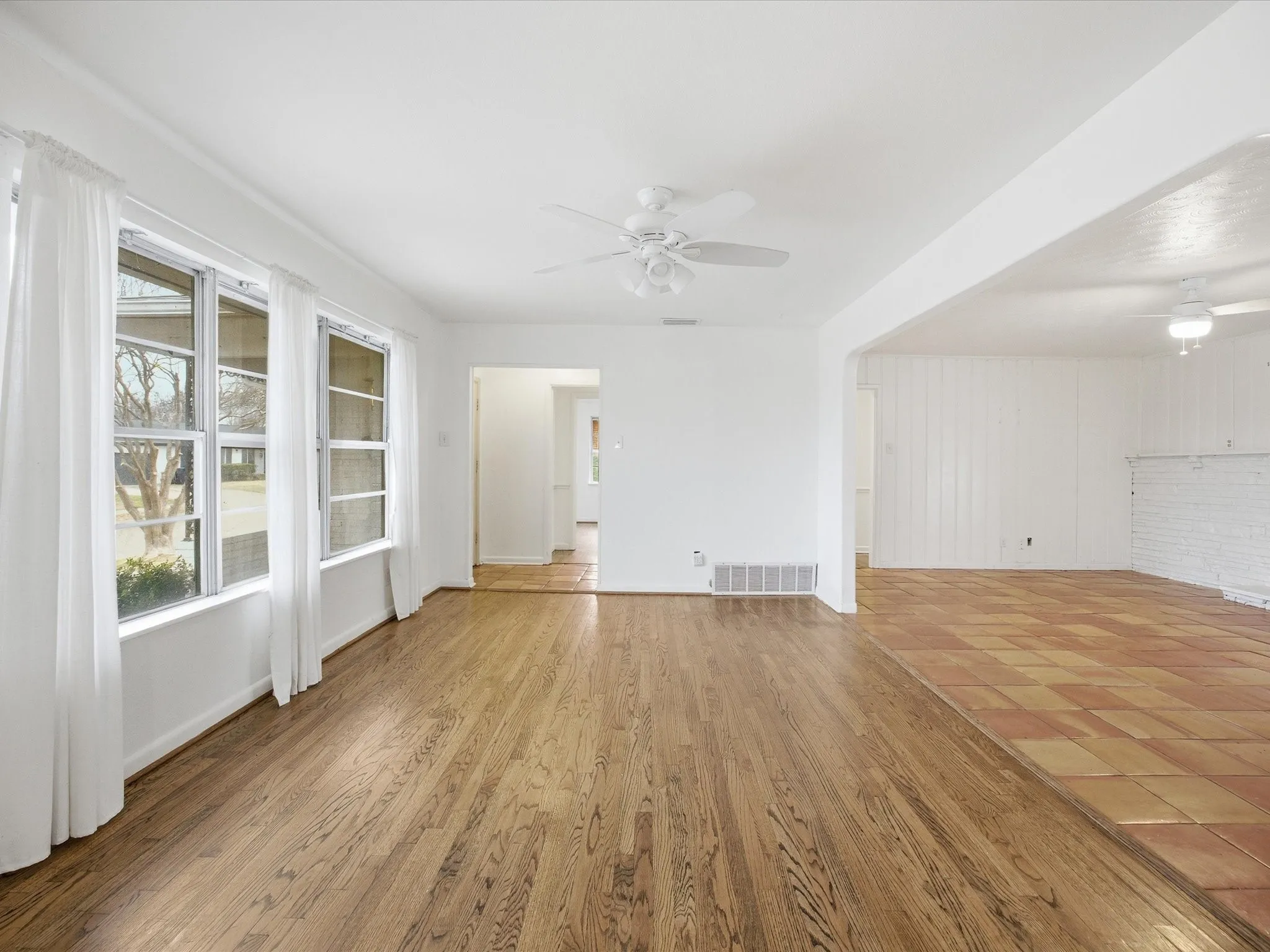 Unfurnished living room featuring ceiling fan and light wood-style floors