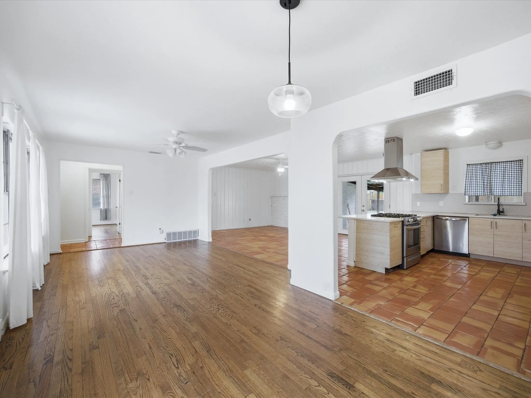 Kitchen with open floor plan, light countertops, light wood finish cabinetry, and dark wood-style floors
