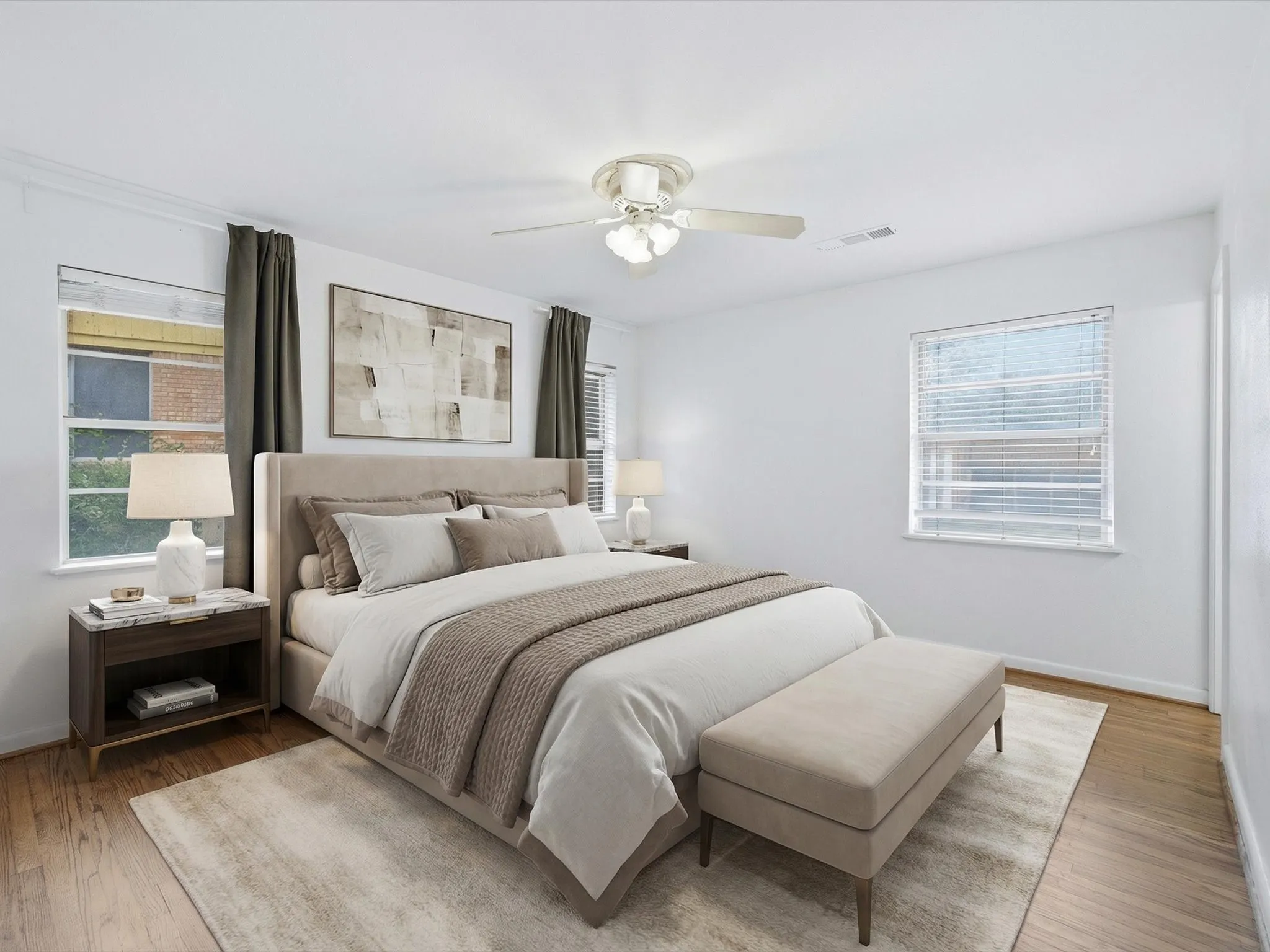 Primary Bedroom with wood finished floors, multiple windows, and a ceiling fan