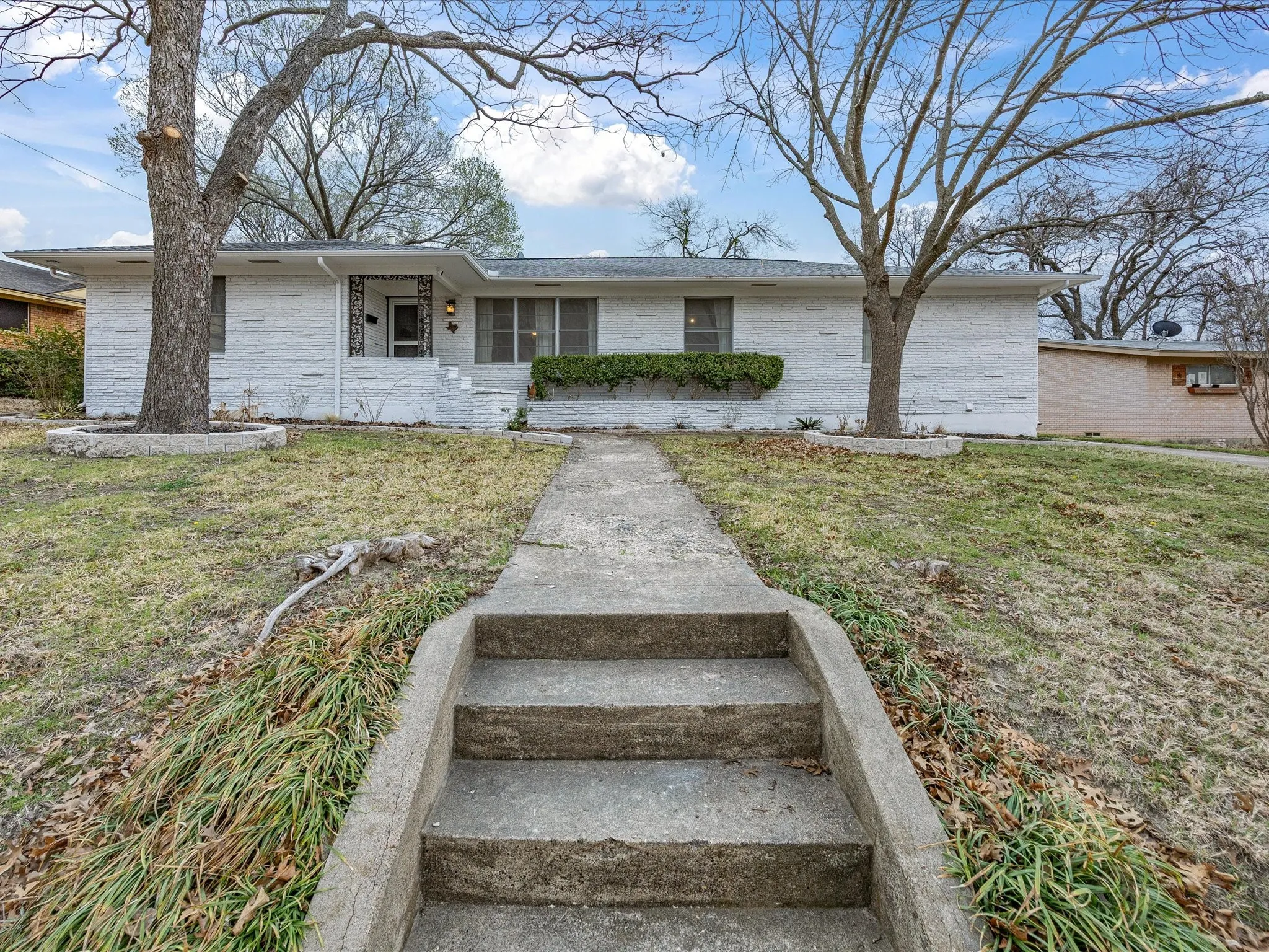 Ranch-style house with a front lawn and brick siding