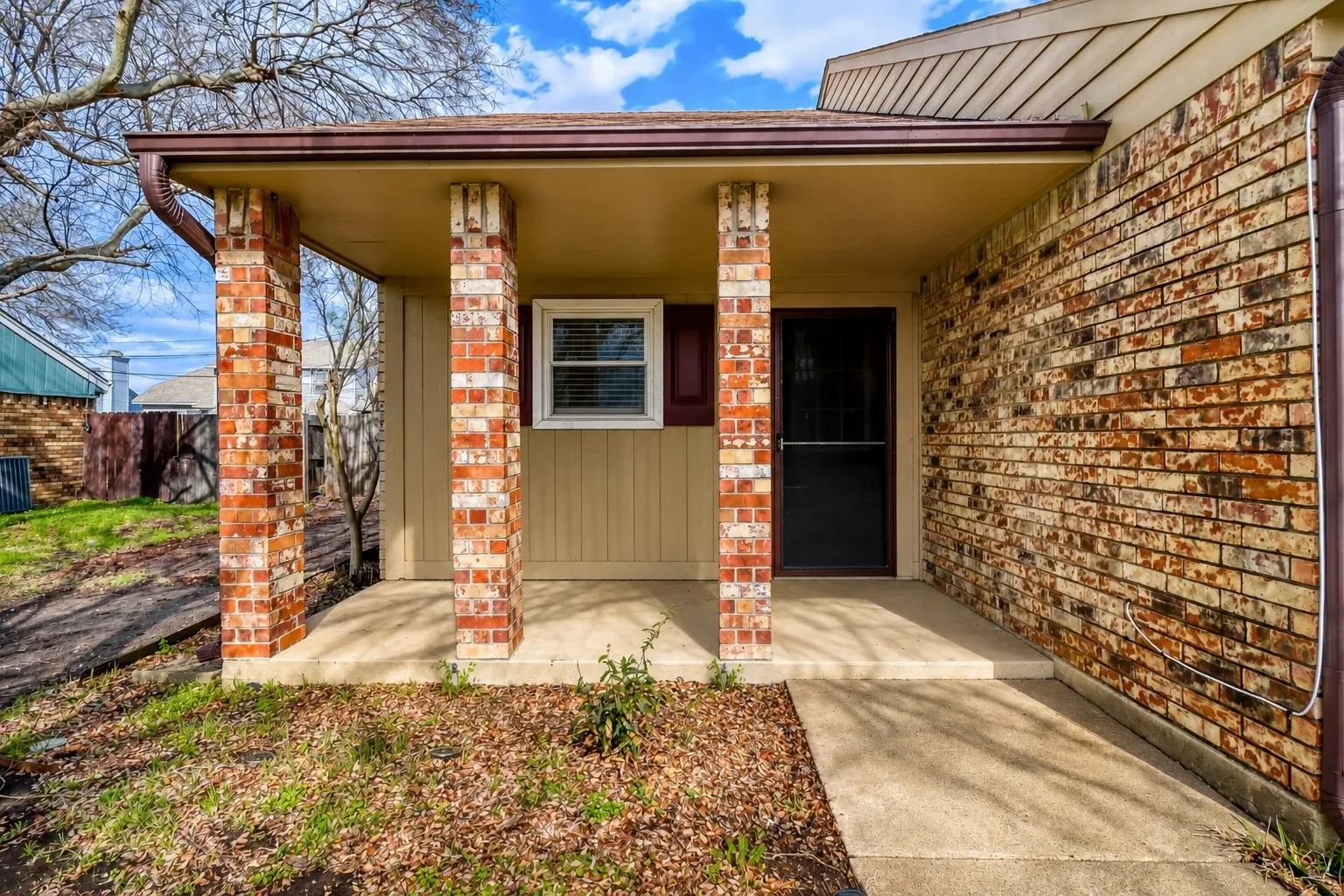 Front entry with brick columns and a covered porch