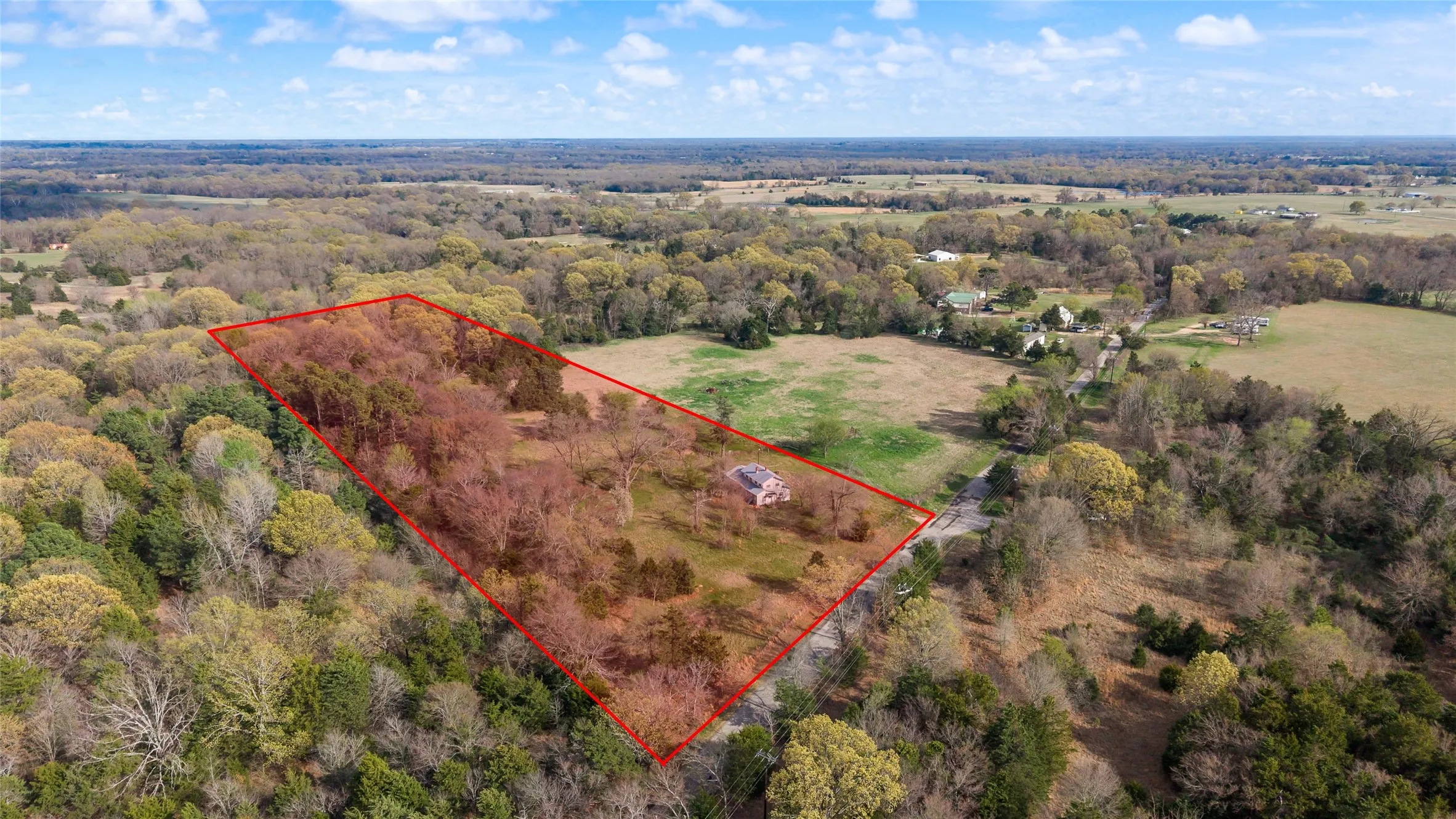 View of property location with property parcel outlined and a forest