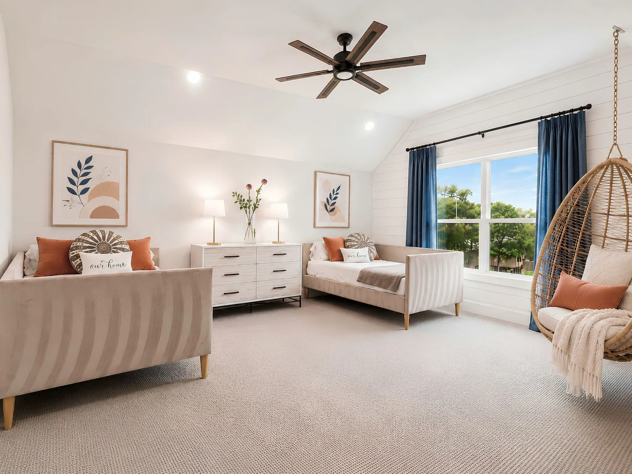 Vaulted ceiling room featuring a ceiling fan, shiplap accent wall, large window with outdoor greenery, and light-toned carpet flooring