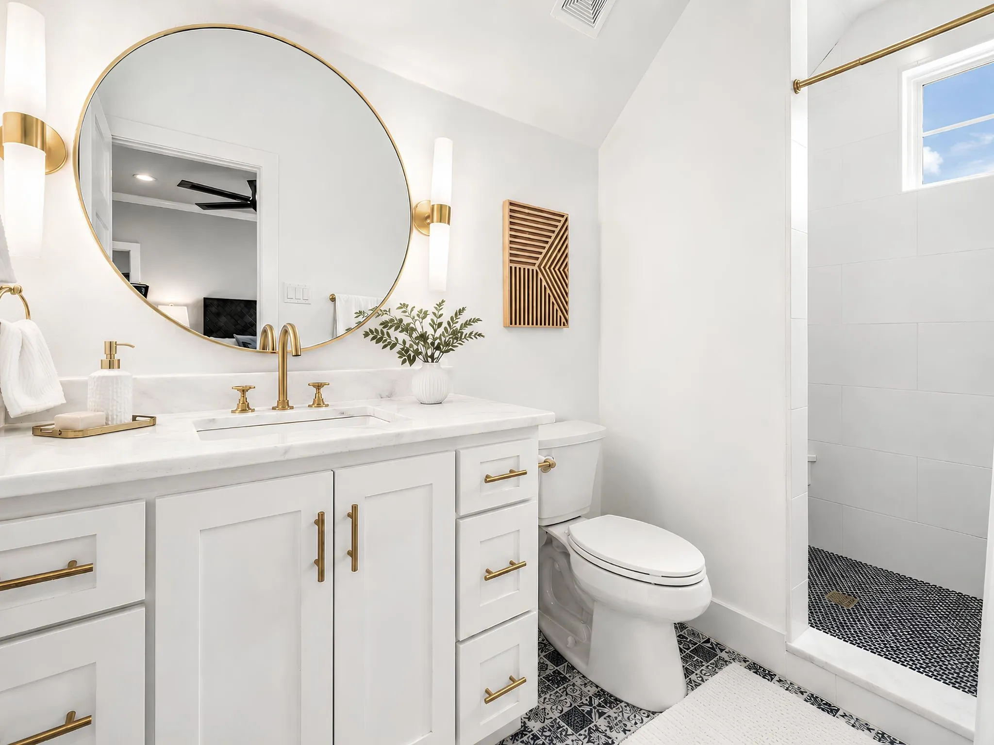 White shaker vanity with gold-tone hardware, marble-finish countertop, and undermount sink