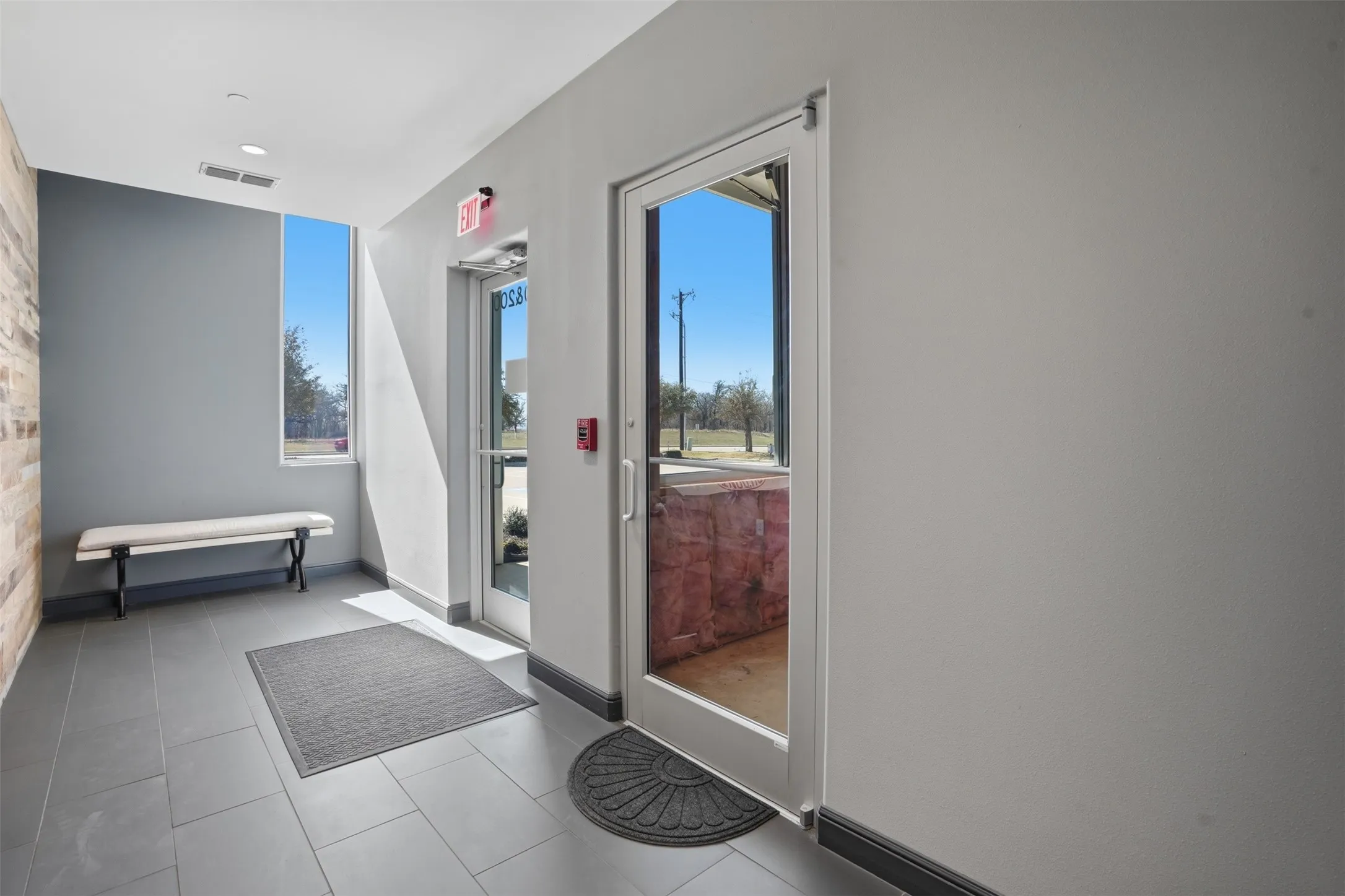 Doorway featuring baseboards and tile patterned flooring