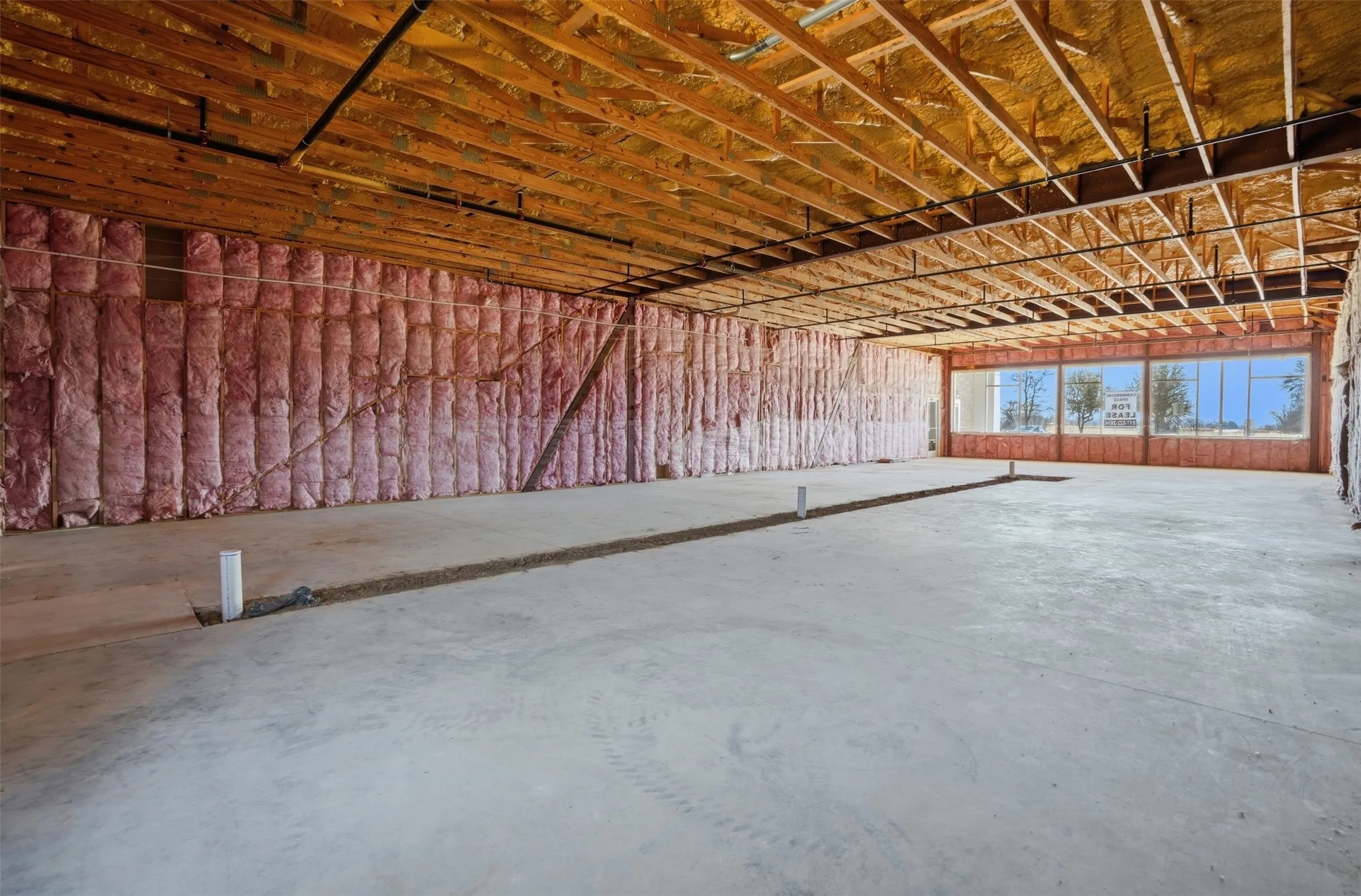 Misc room featuring unfinished concrete floors and a garage