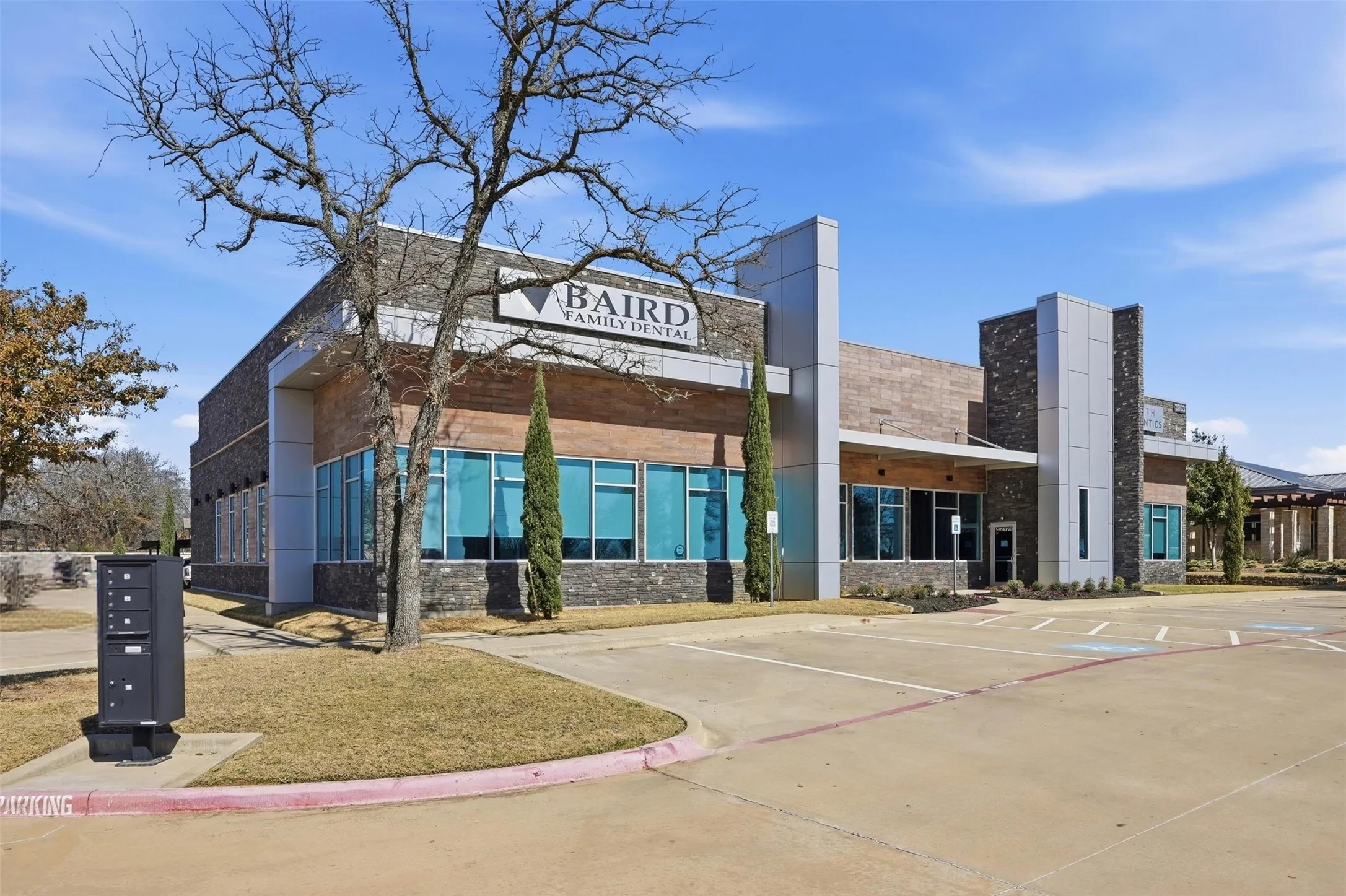 View of commercial property featuring uncovered parking