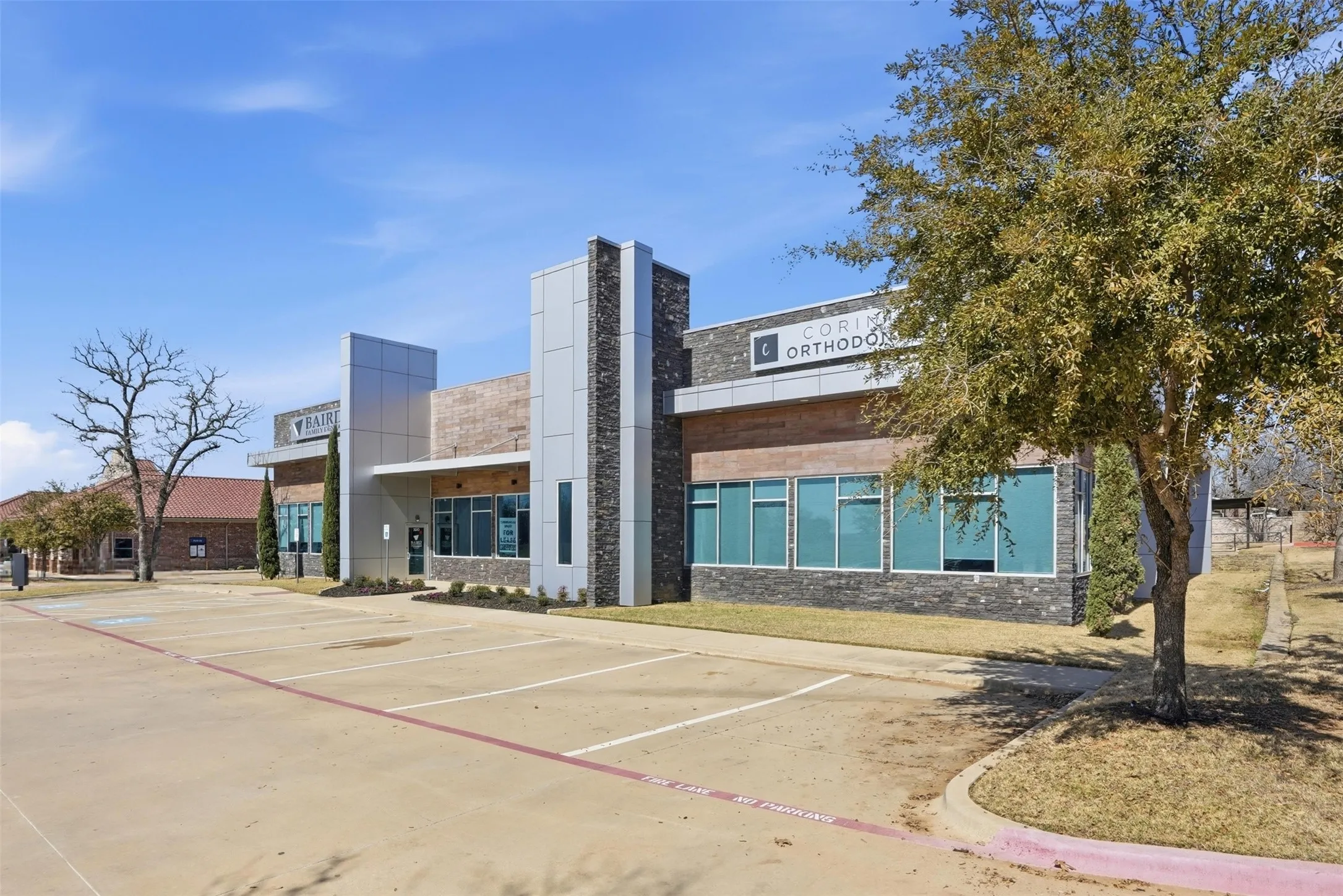 View of commercial location featuring uncovered parking