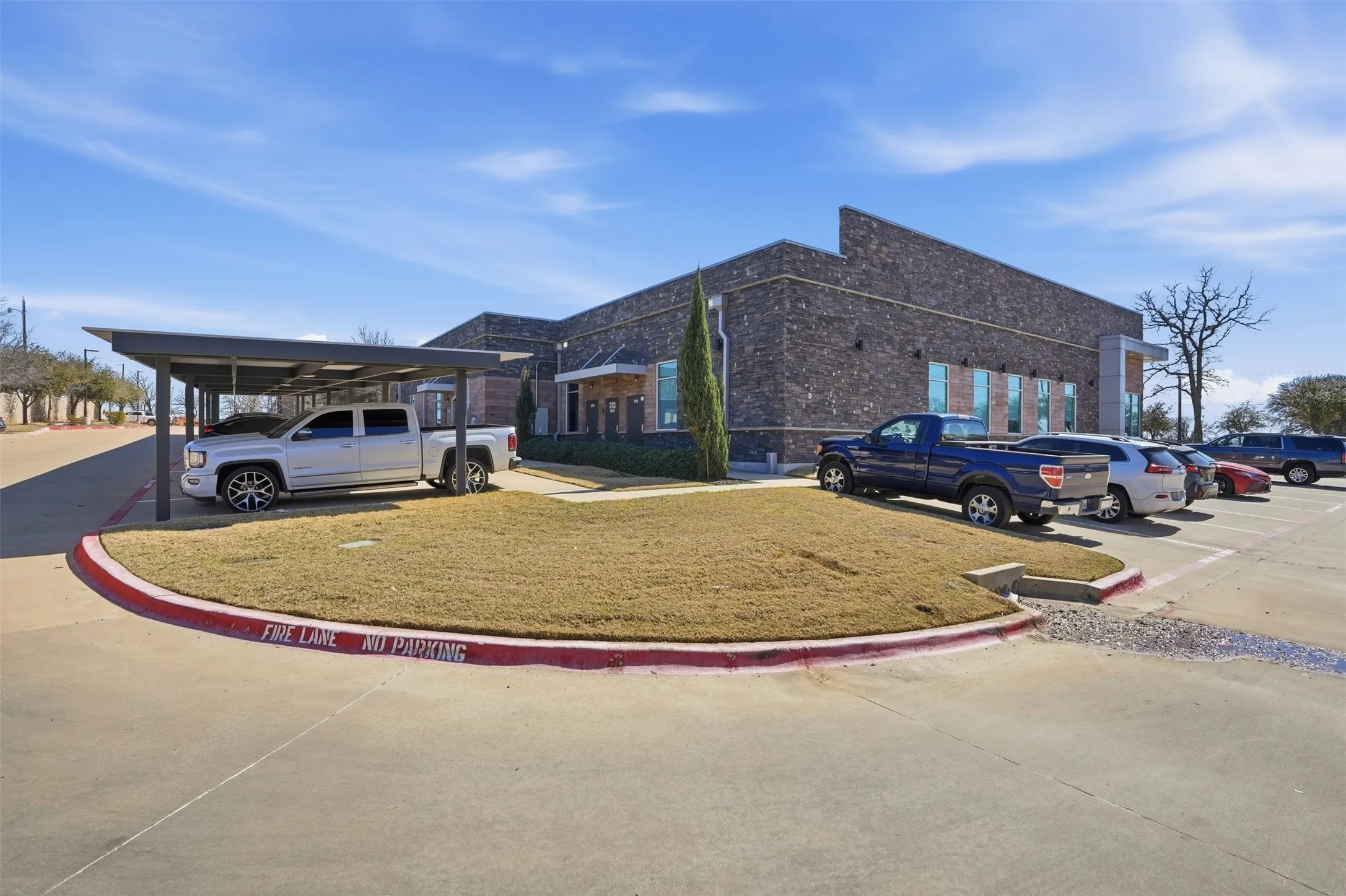 View of property exterior featuring a yard and uncovered parking