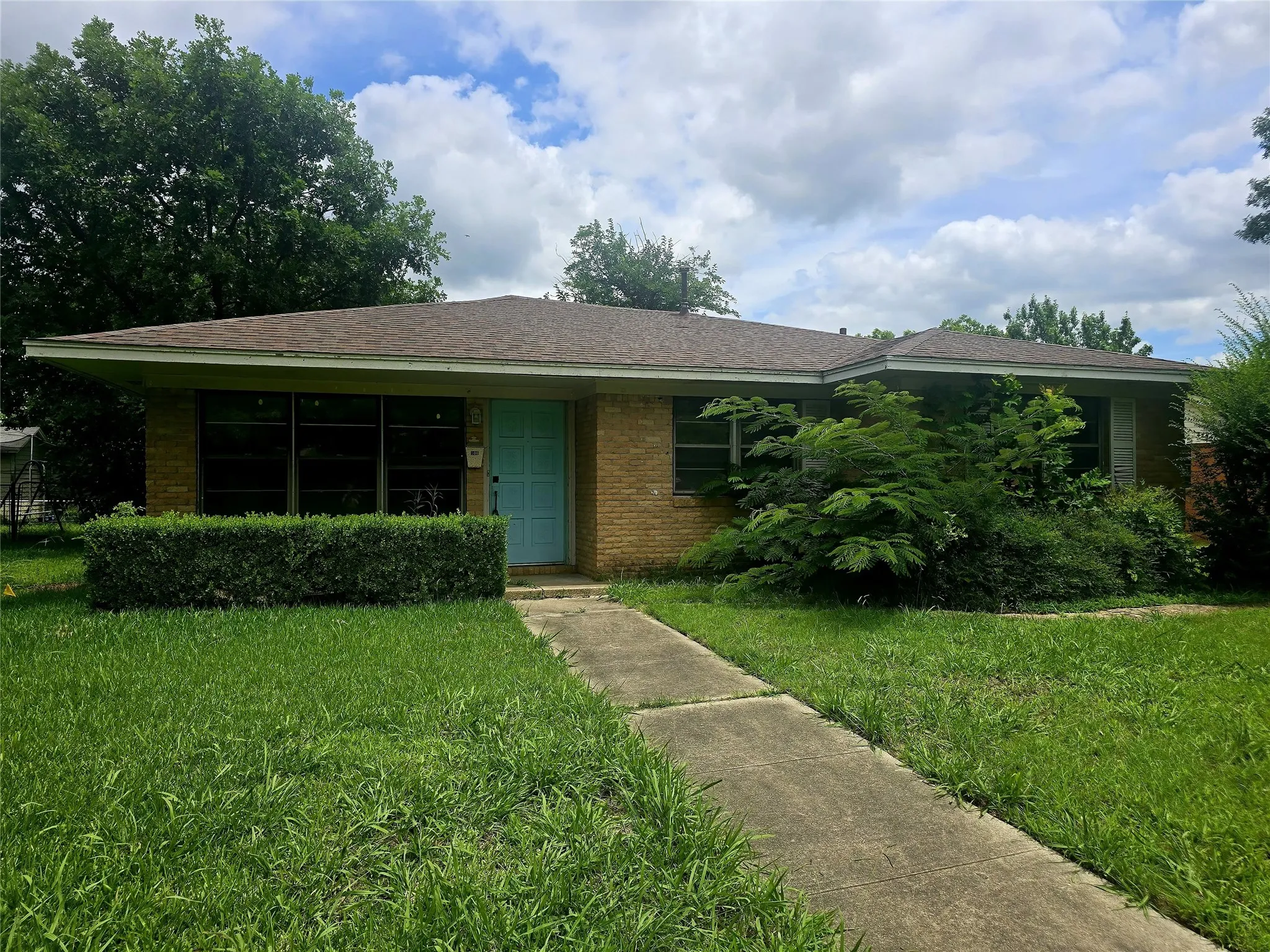 Brick exterior with a turquoise entry door