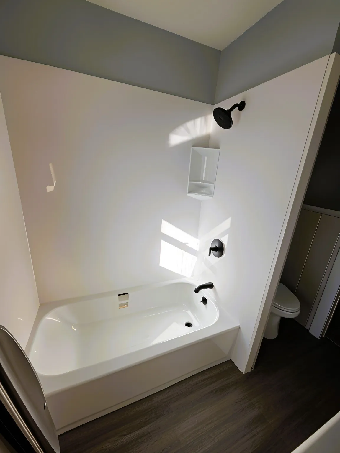 Full bathroom featuring dark wood finished floors and shower / tub combination