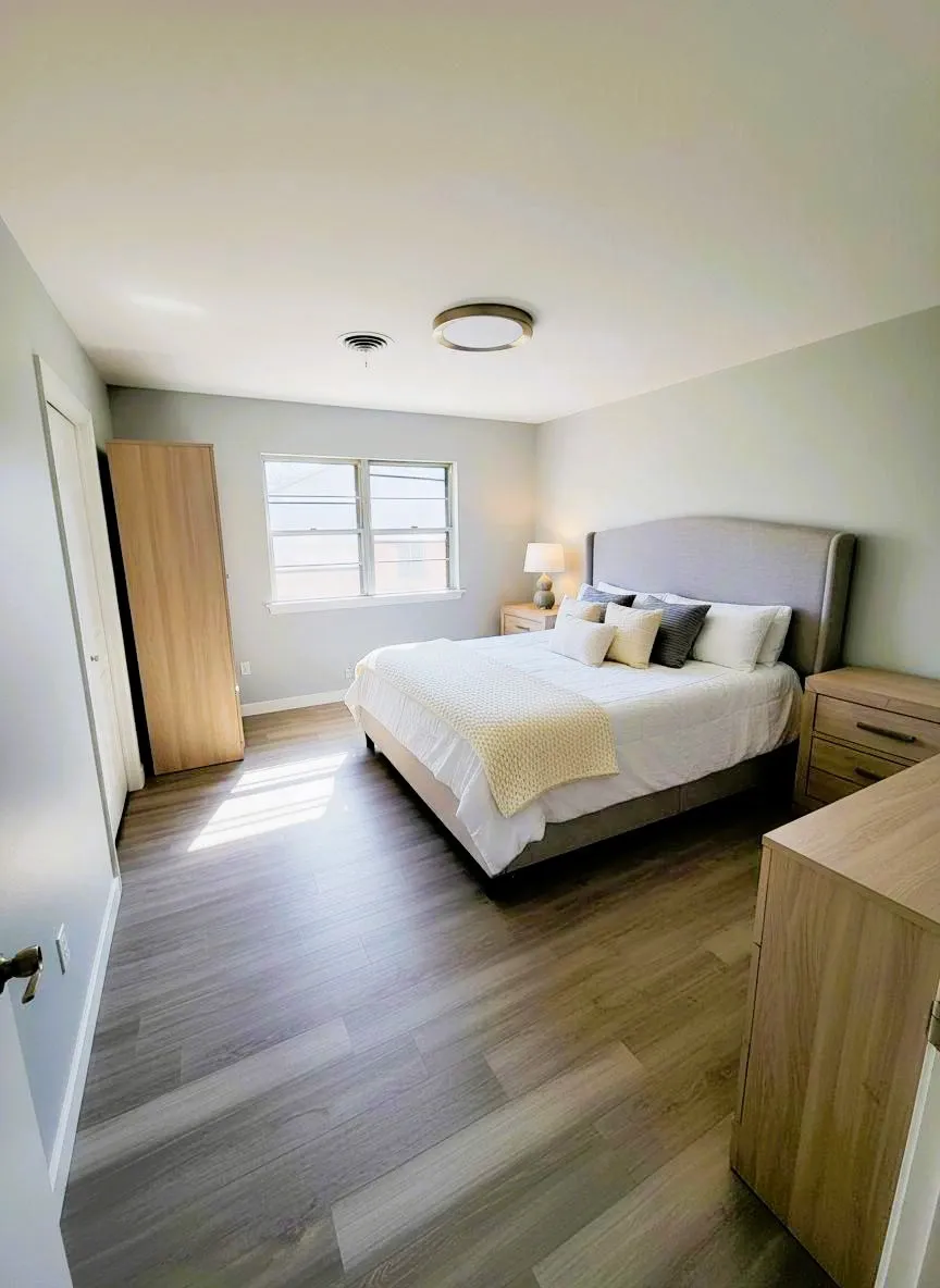 Bedroom featuring dark wood-style flooring. Virtual Staging