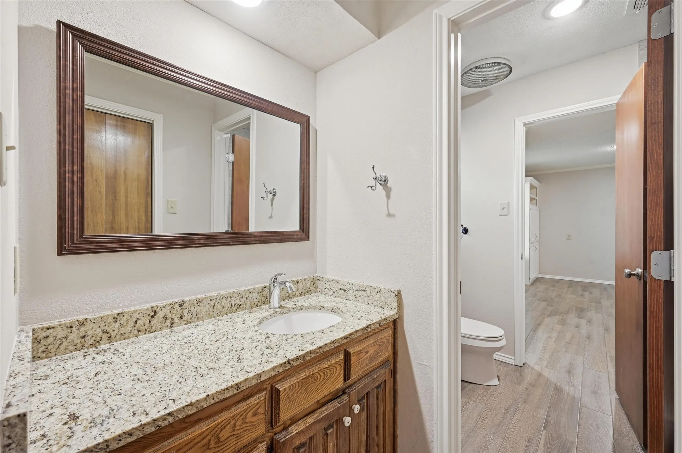 Bathroom featuring vanity, light wood finished floors, and recessed lighting