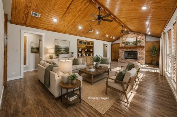 Spacious living area featuring a vaulted wood-paneled ceiling with recessed lighting and ceiling fans