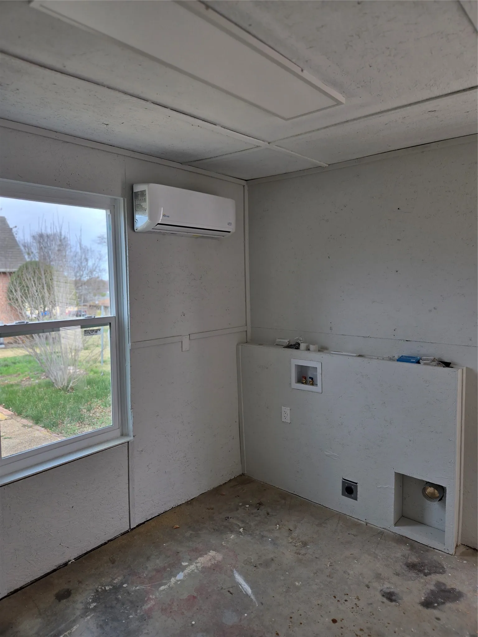Laundry room with unfinished concrete floors, washer hookup, and electric dryer hookup