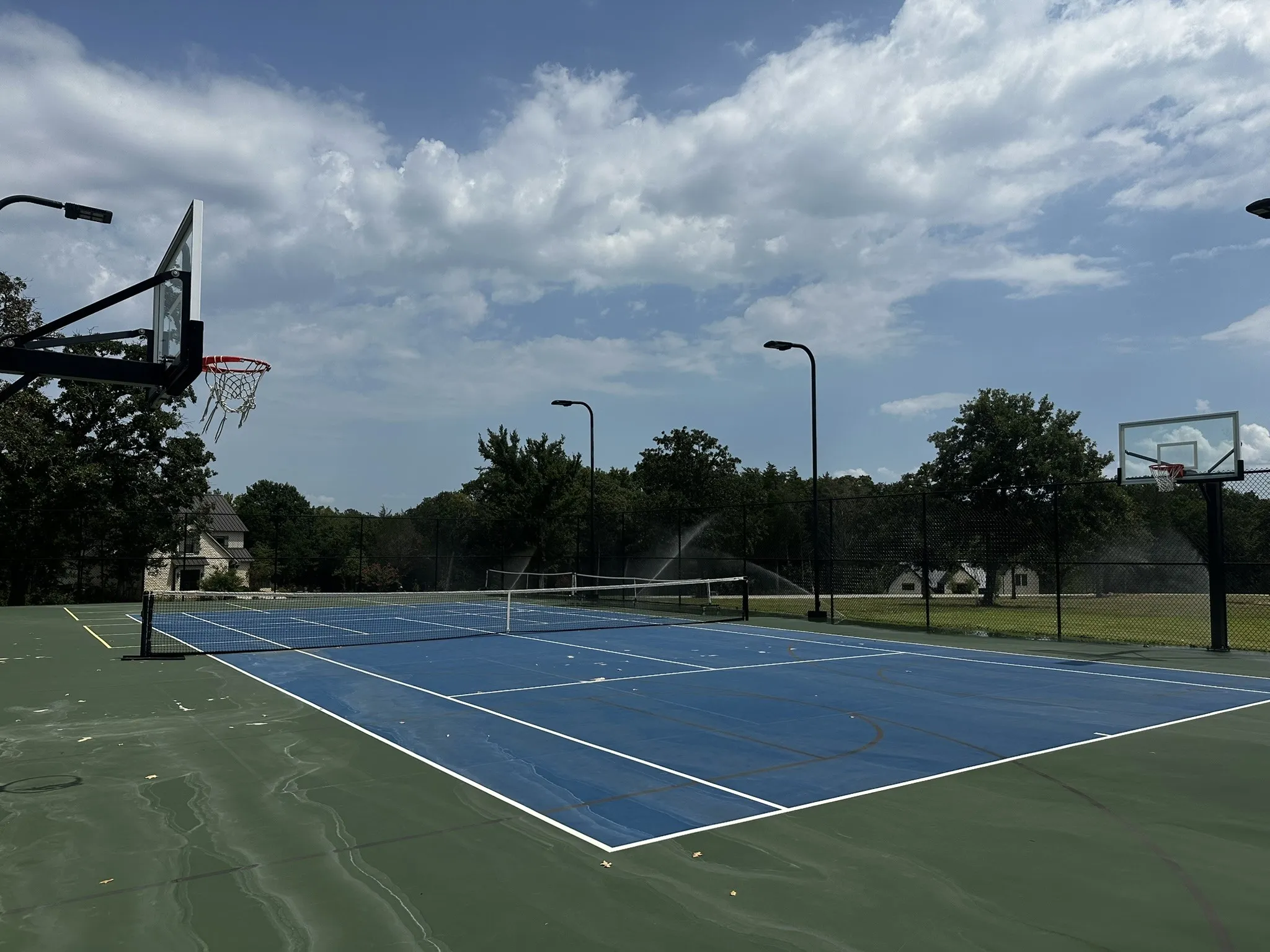 View of tennis court featuring community basketball court