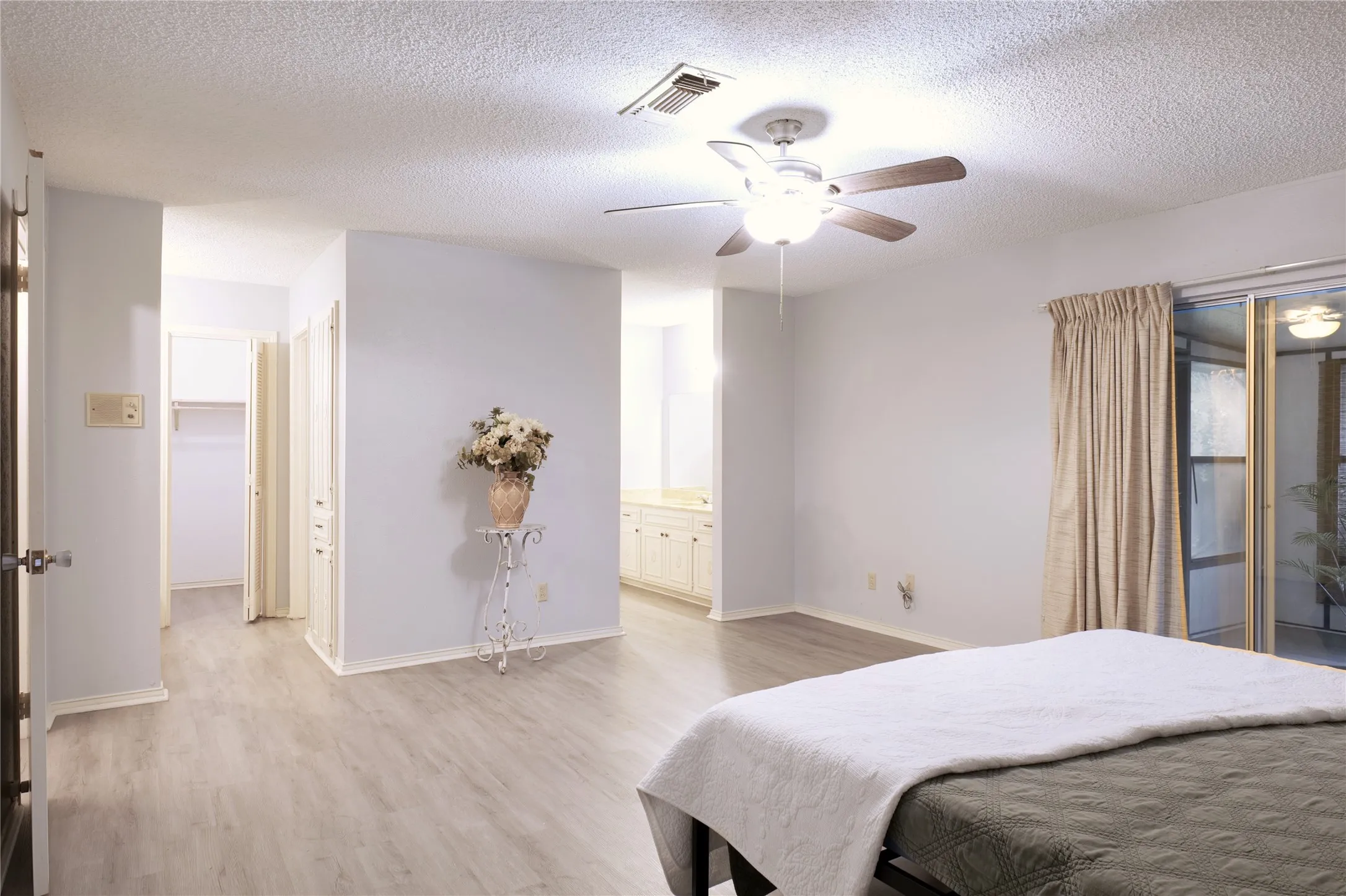 Primary Bedroom featuring his and her bathroom, two separate vanities, and two walk in closets.