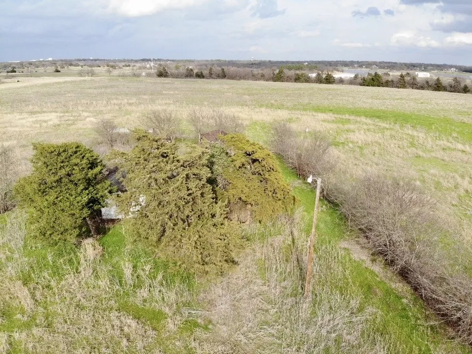 Welcome to 1900 Nesuda Rd., Ennis, TX 75119
Areial view over house & property, facing East