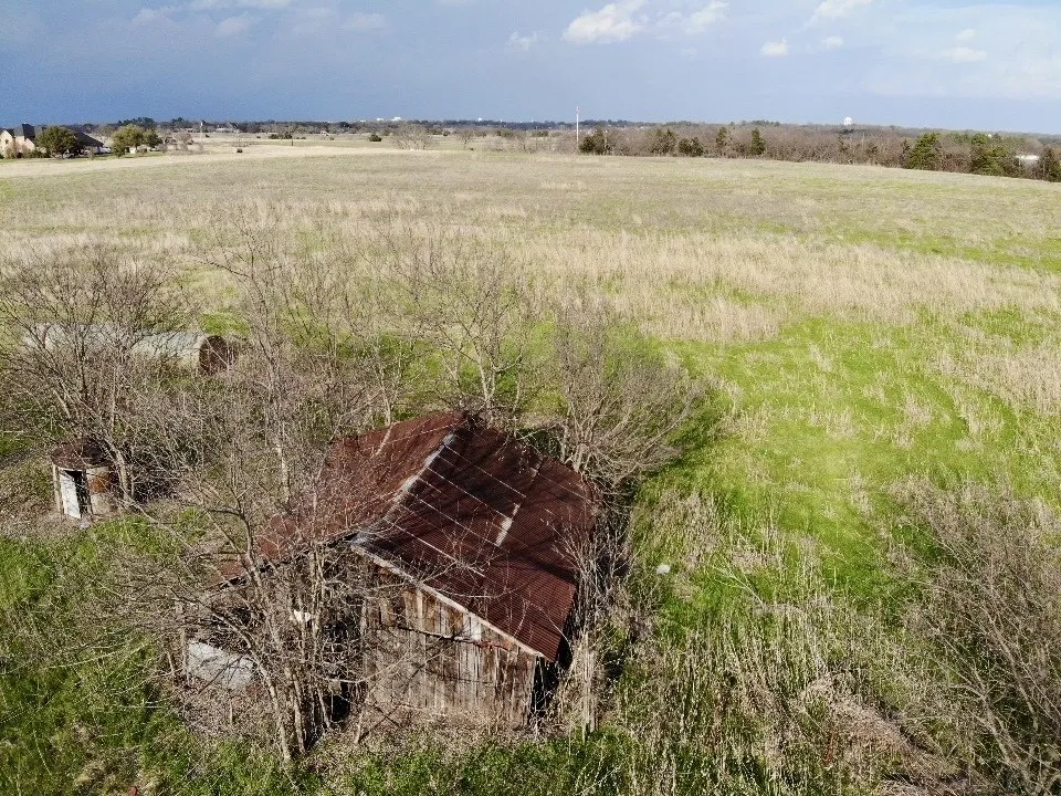 Aerial view over barn looking to the East & back of the property.