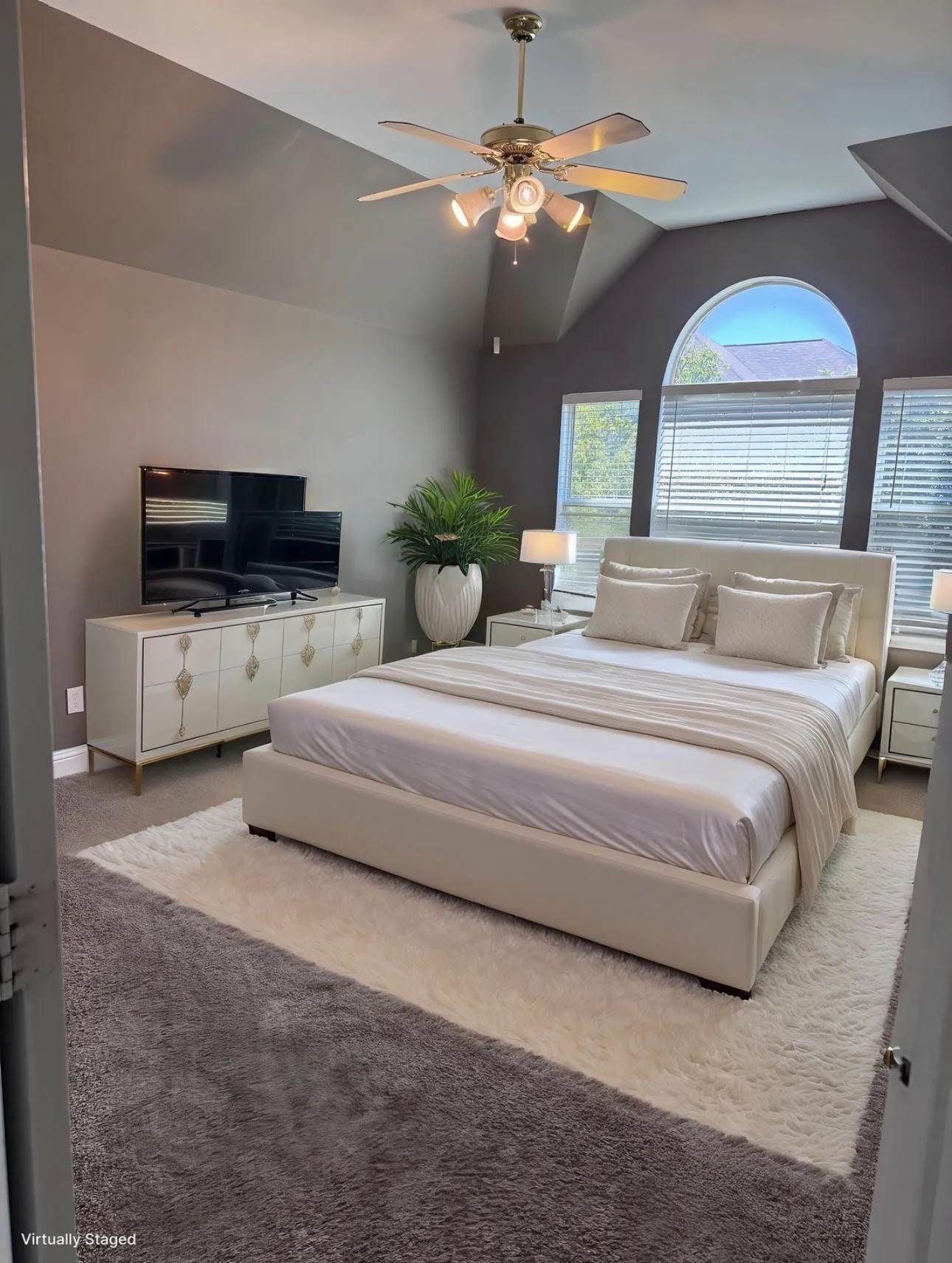 Bedroom featuring ceiling fan, carpet floors, and vaulted ceiling