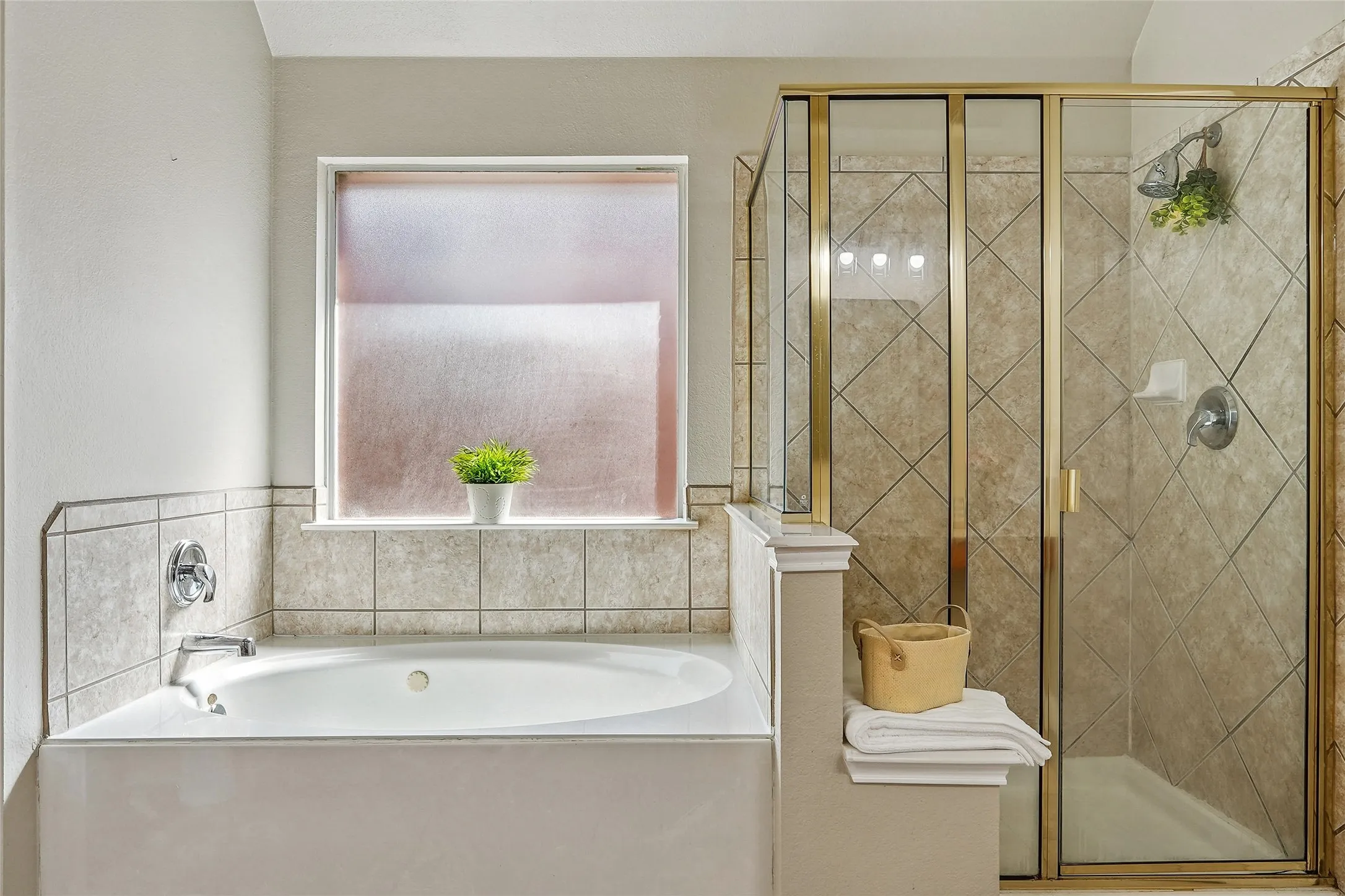 Full bath with a shower stall and a bath