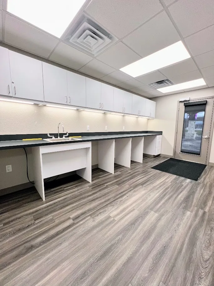 Kitchen featuring white cabinets, a paneled ceiling, and dark countertops