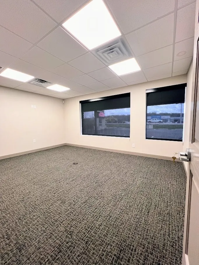 Spare room with a paneled ceiling and carpet