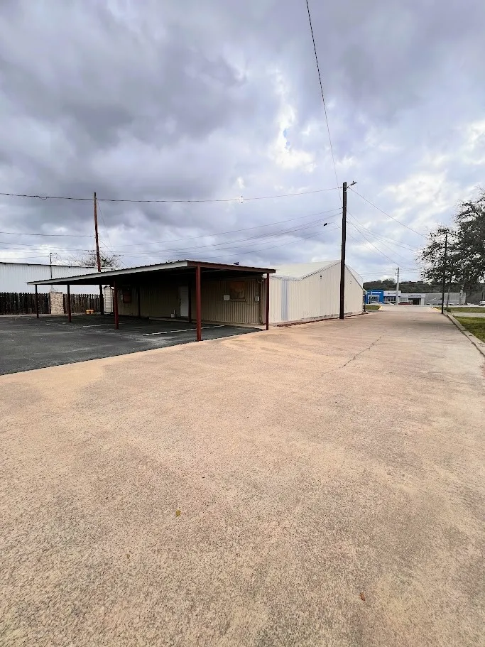 View of parking featuring a carport