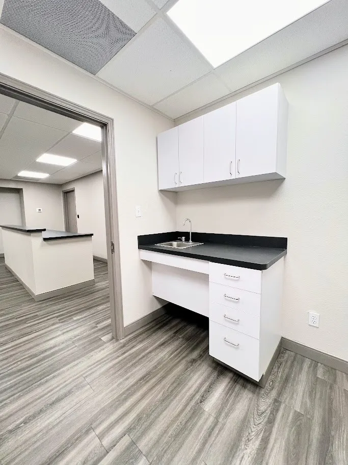 Unfurnished office with a paneled ceiling and light wood-style floors