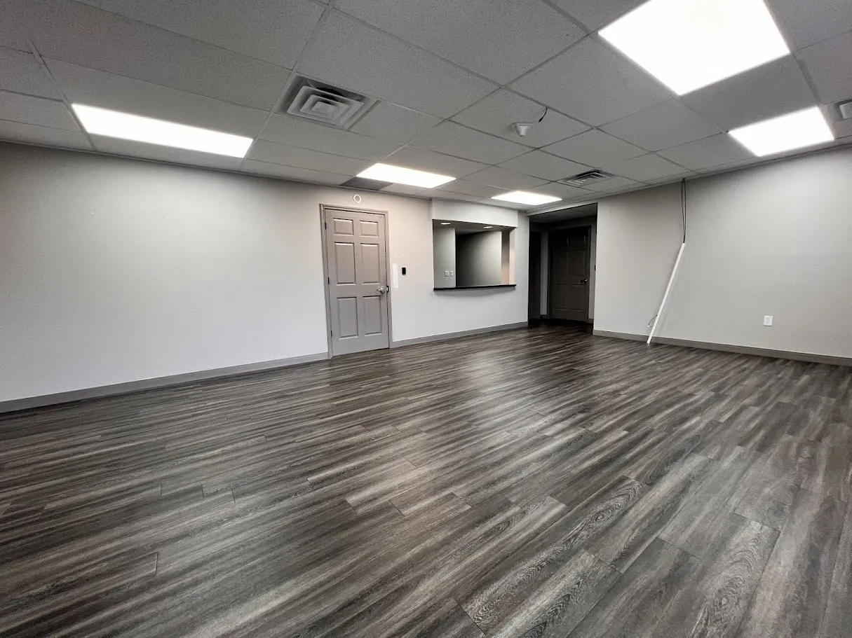Spare room with dark wood-style floors and a paneled ceiling