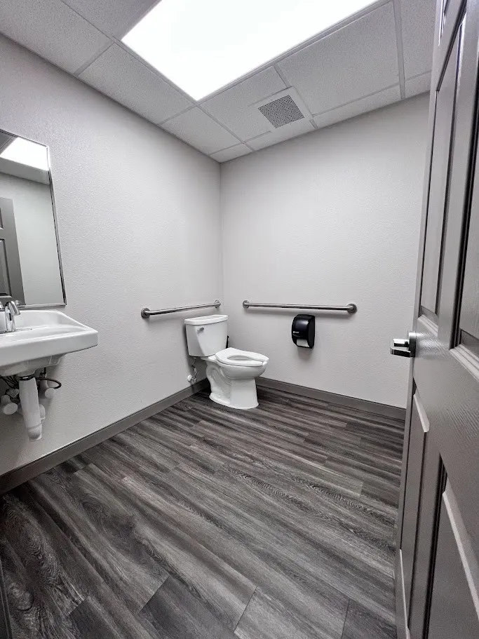 Half bath with toilet and a paneled ceiling