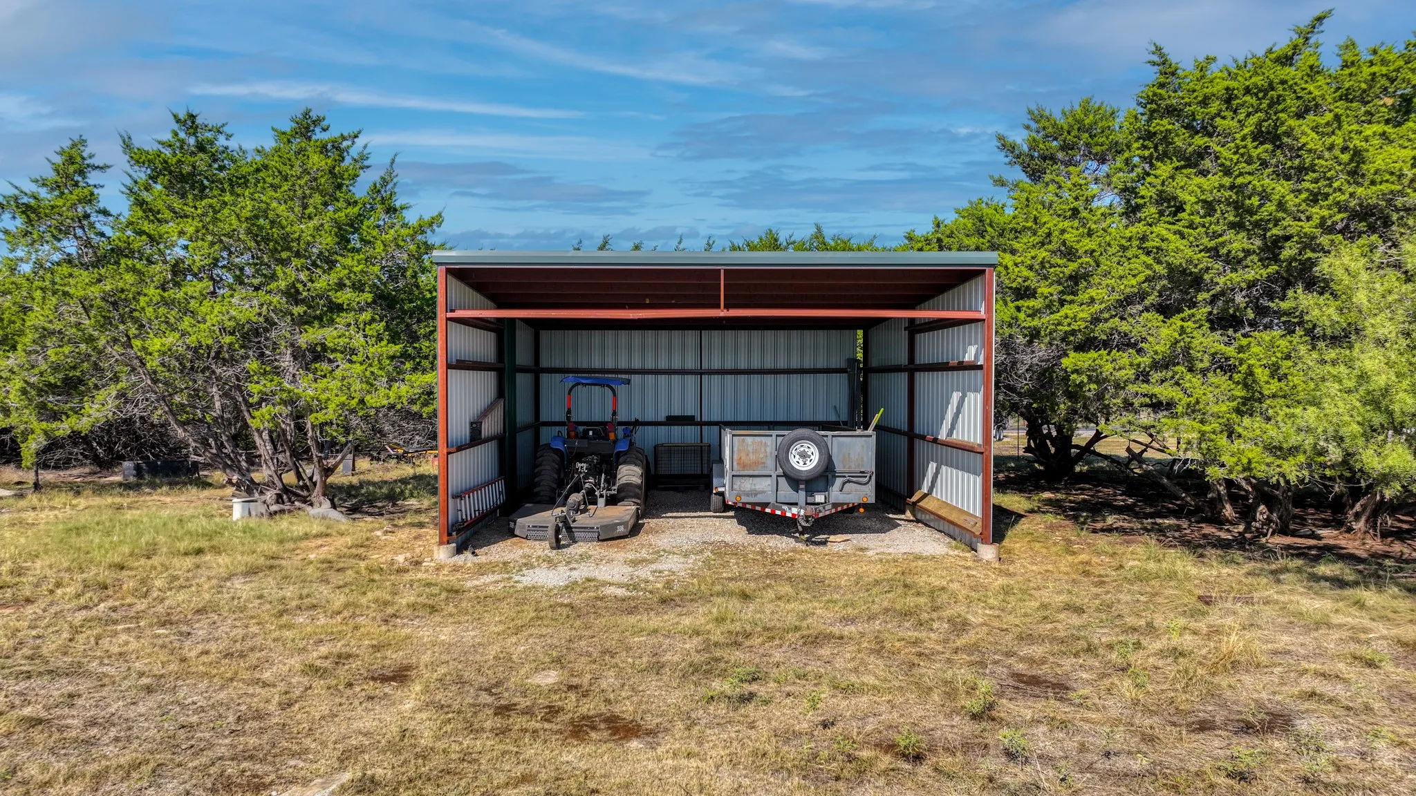 Huge bonus! A covered hidden pole barn - 30' deep, 25' wide, and 12 ' tall for clearance - can house an RV, boat, tractor, trailers, extra car, tools, etc.