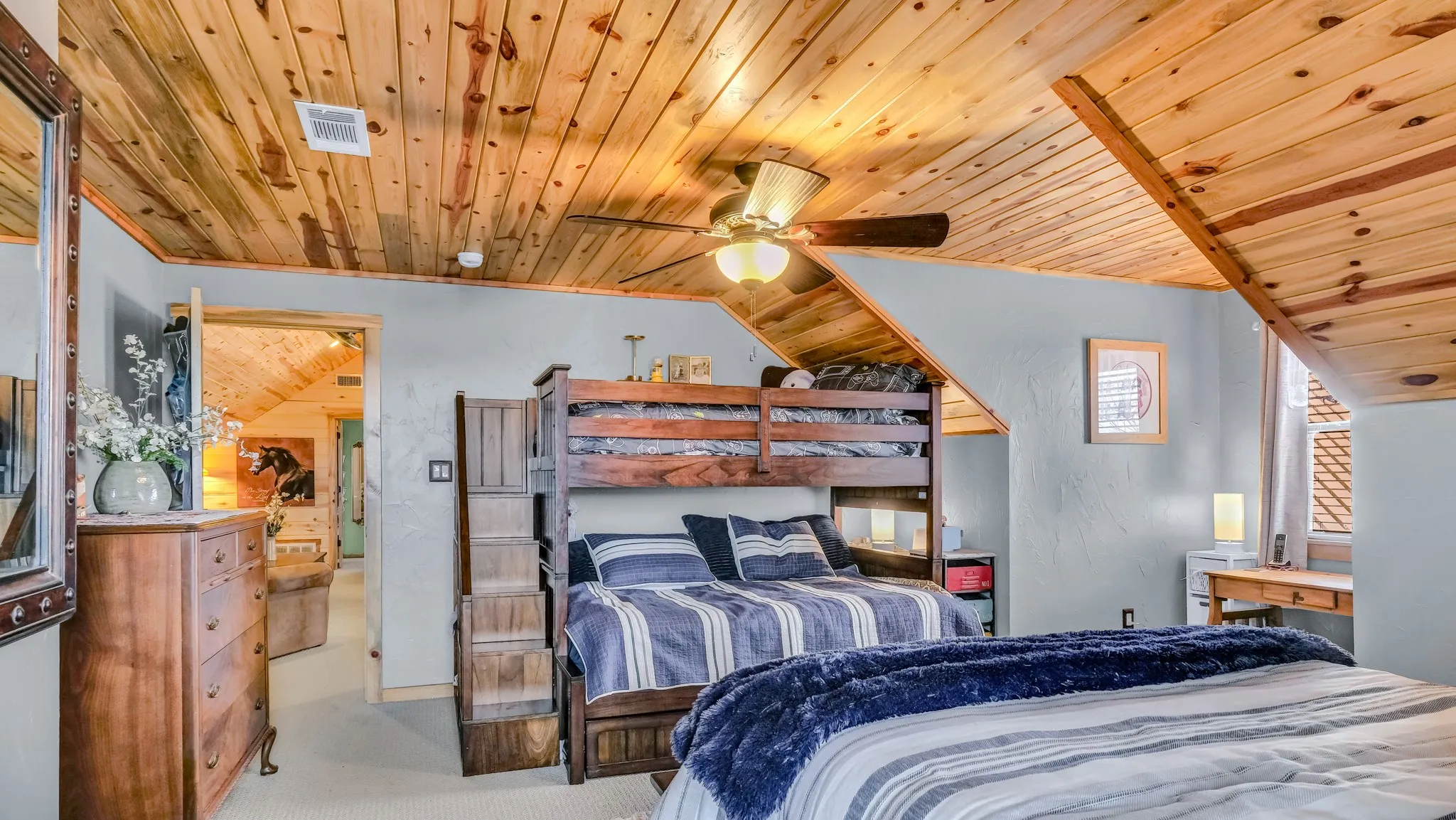 Large secondary room upstairs has a queen bed and a bunk bed with a full bottom mattress, alcove and room to spare! It has its own full bathroom