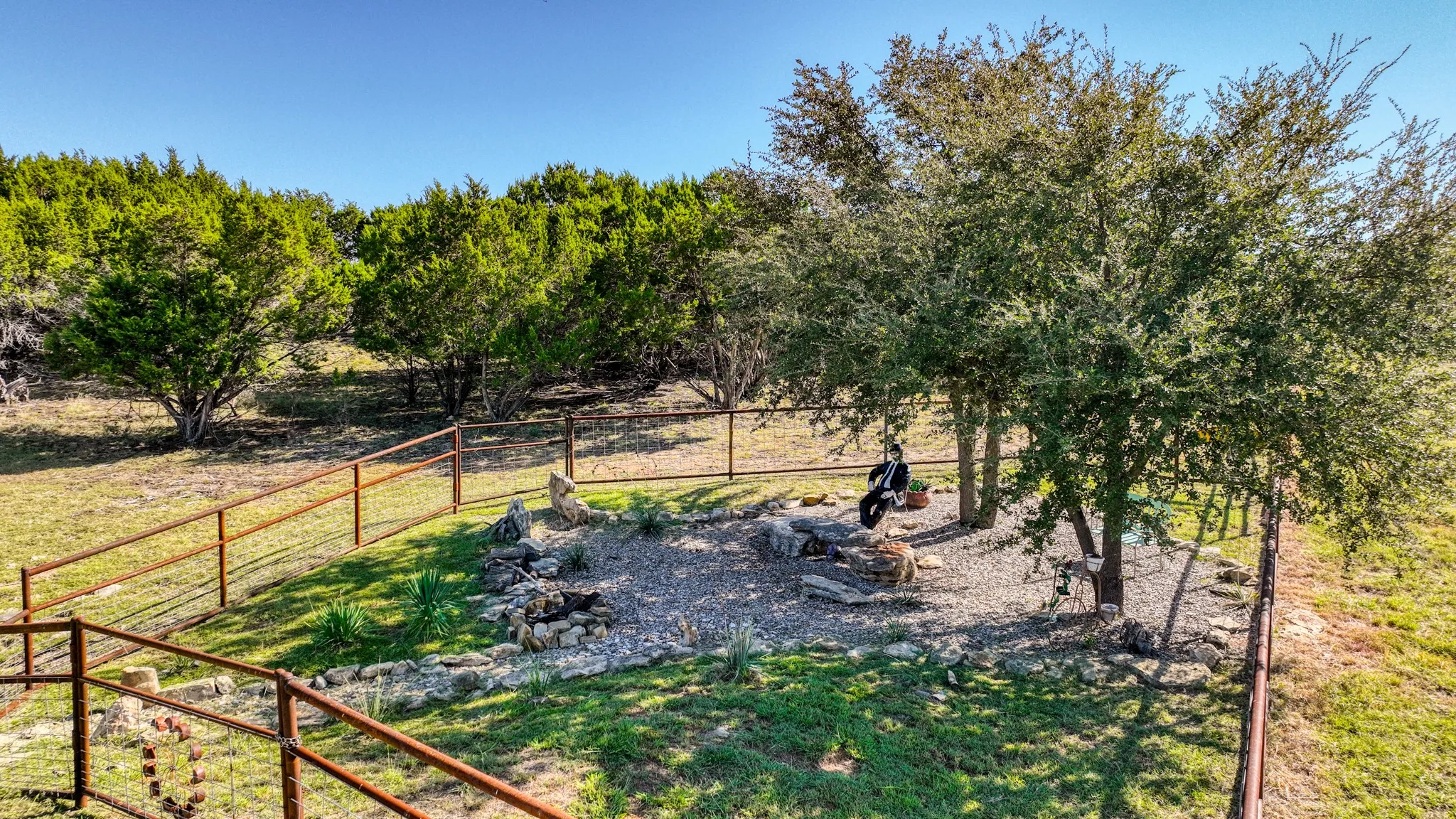 Another great sitting place at the pond under the oak trees in which to escape the stresses of life. Another fire pit is there for your enjoyment.