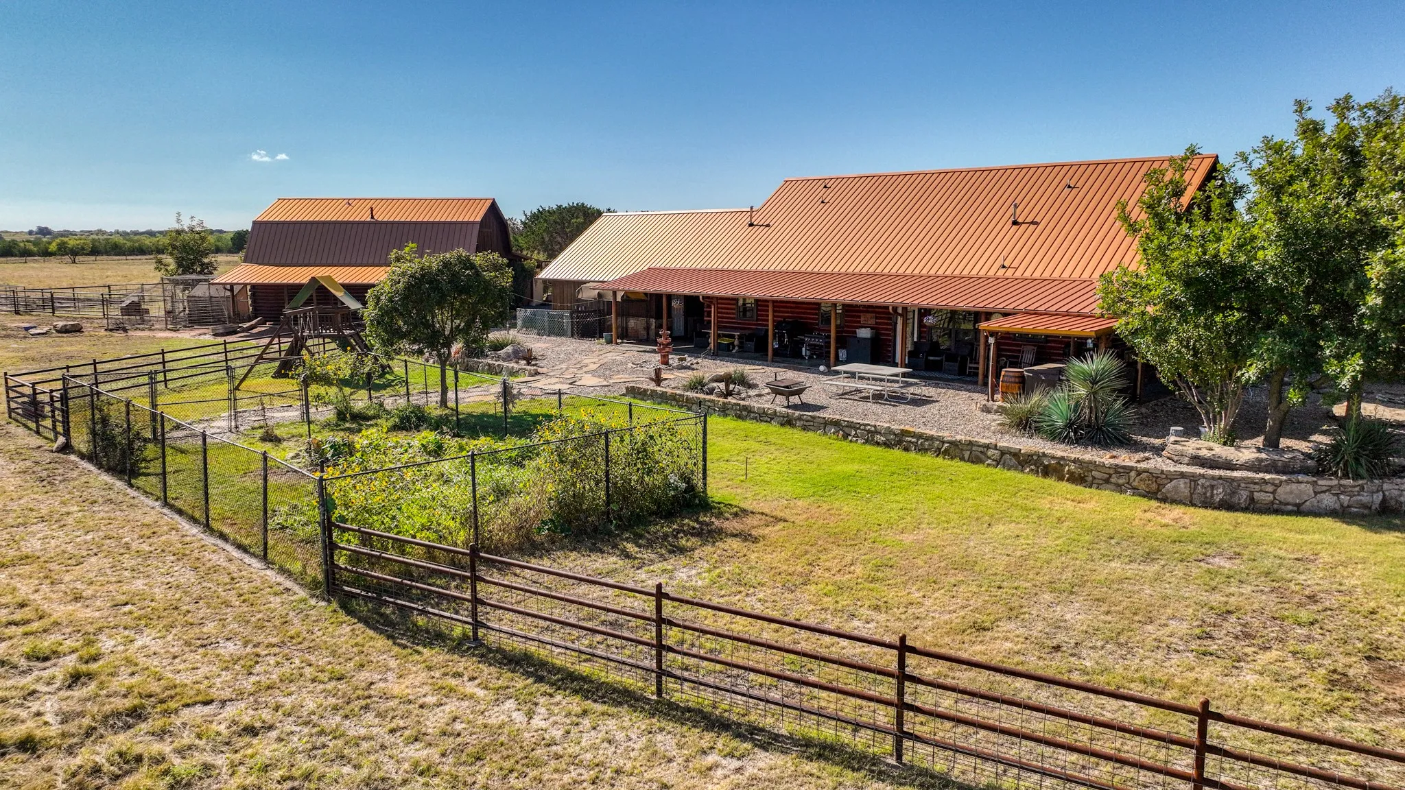 Back yard of this property has a huge fenced in garden, hot tub and mature landscaping.