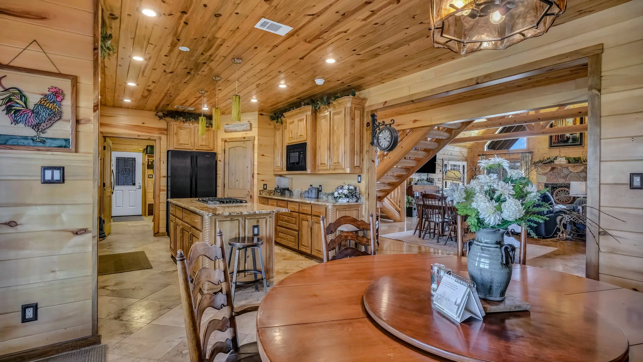 A view from the primary dining area into the kitchen and living area.