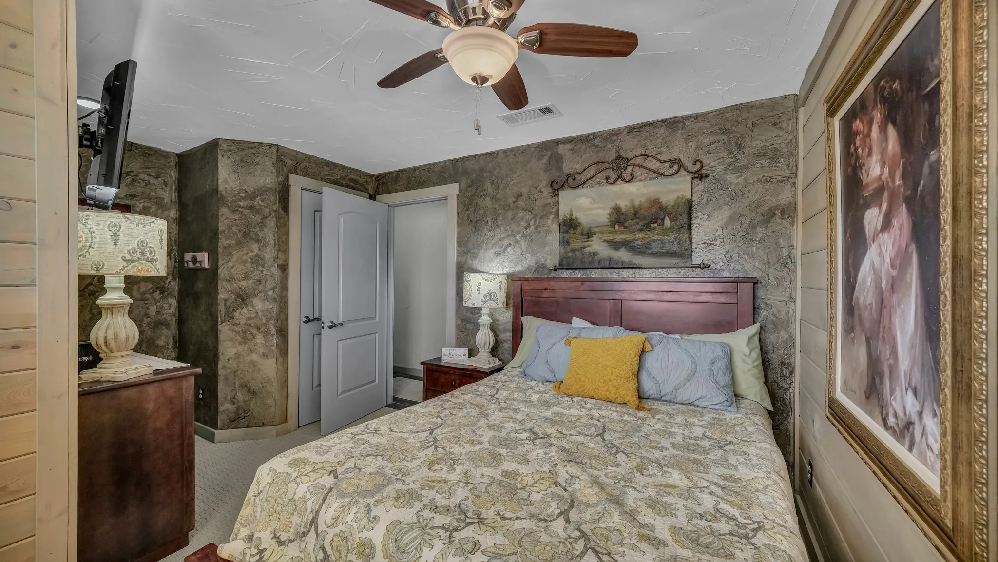 Upstairs barn bedroom has a queen sized bed, full dresser, large window looking outside and ample closet space.