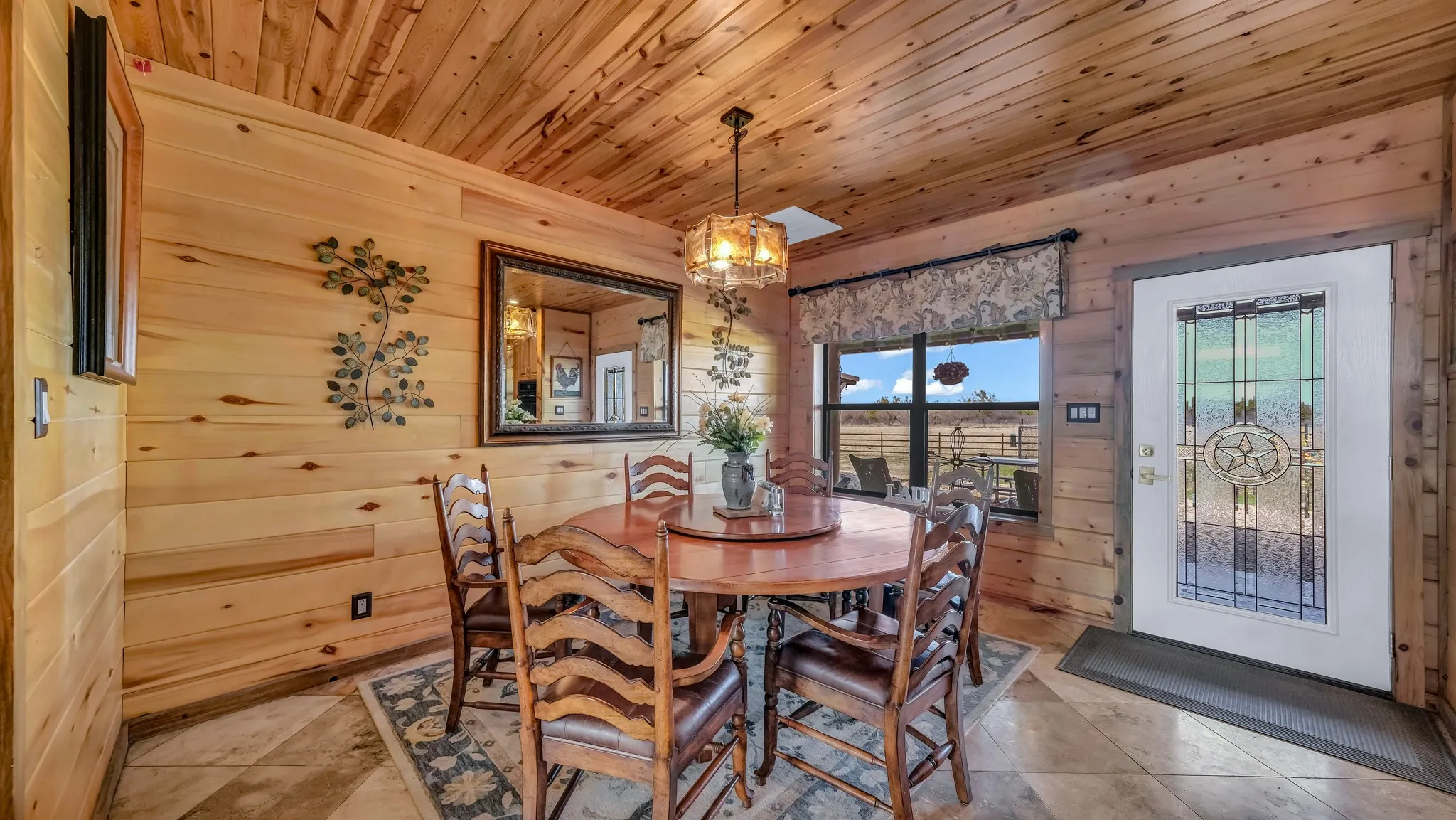 Primary dining area has room for a large circular table that seats 8 and a gorgeous view into the back pasture area.