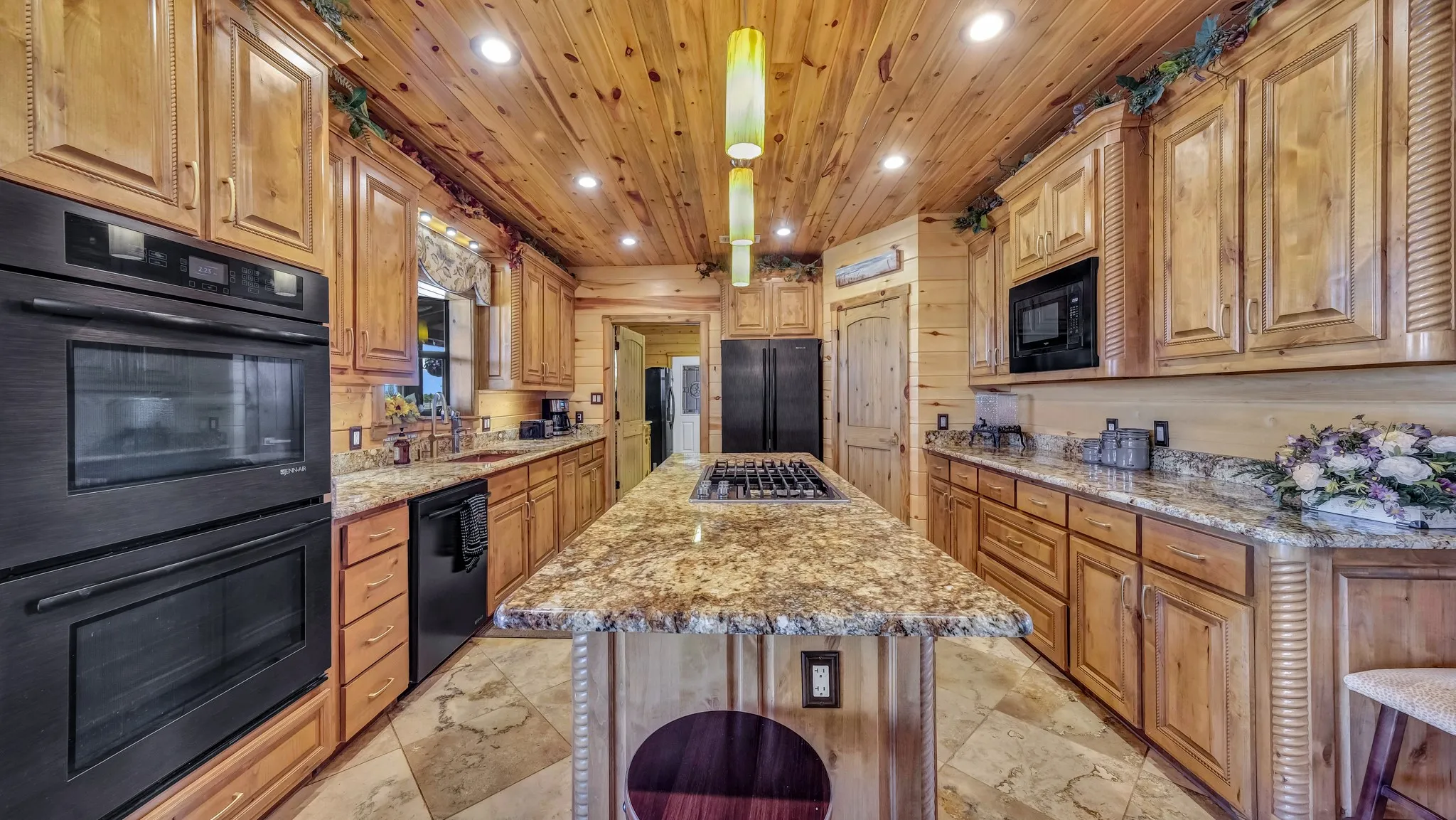 Kitchen appliances are matching bronze colored.  Kitchen leads into laundry room.  Large pantry.