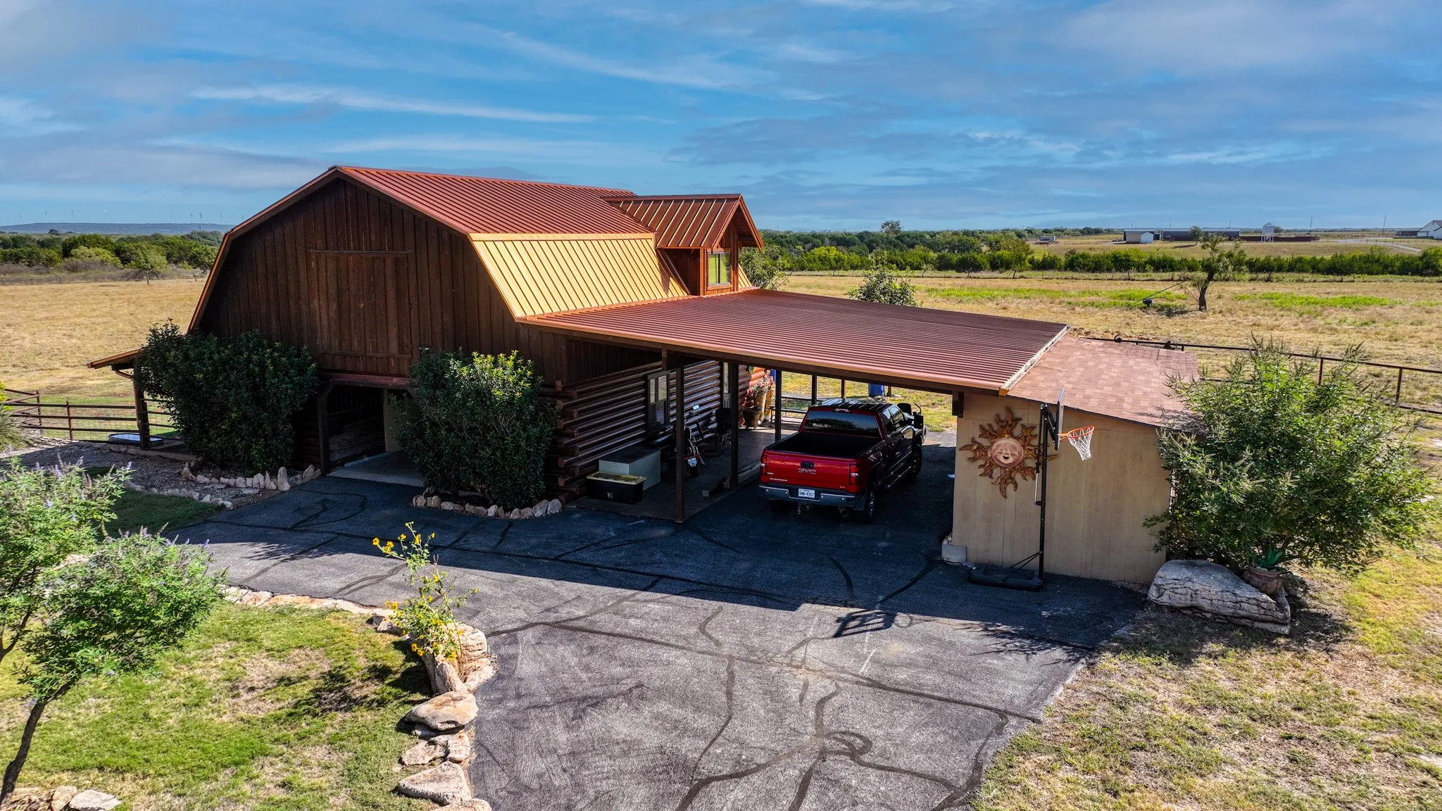 This matching accessory barn has two stalls, a chicken coop, ample storage space in loft, and a one bedroom apartment upstairs with kitchen, Washer/dryer hookup, and a full bath and a living area with a half bath downstairs, Oversized covered porch for trucks, boats, barn dances, etc.