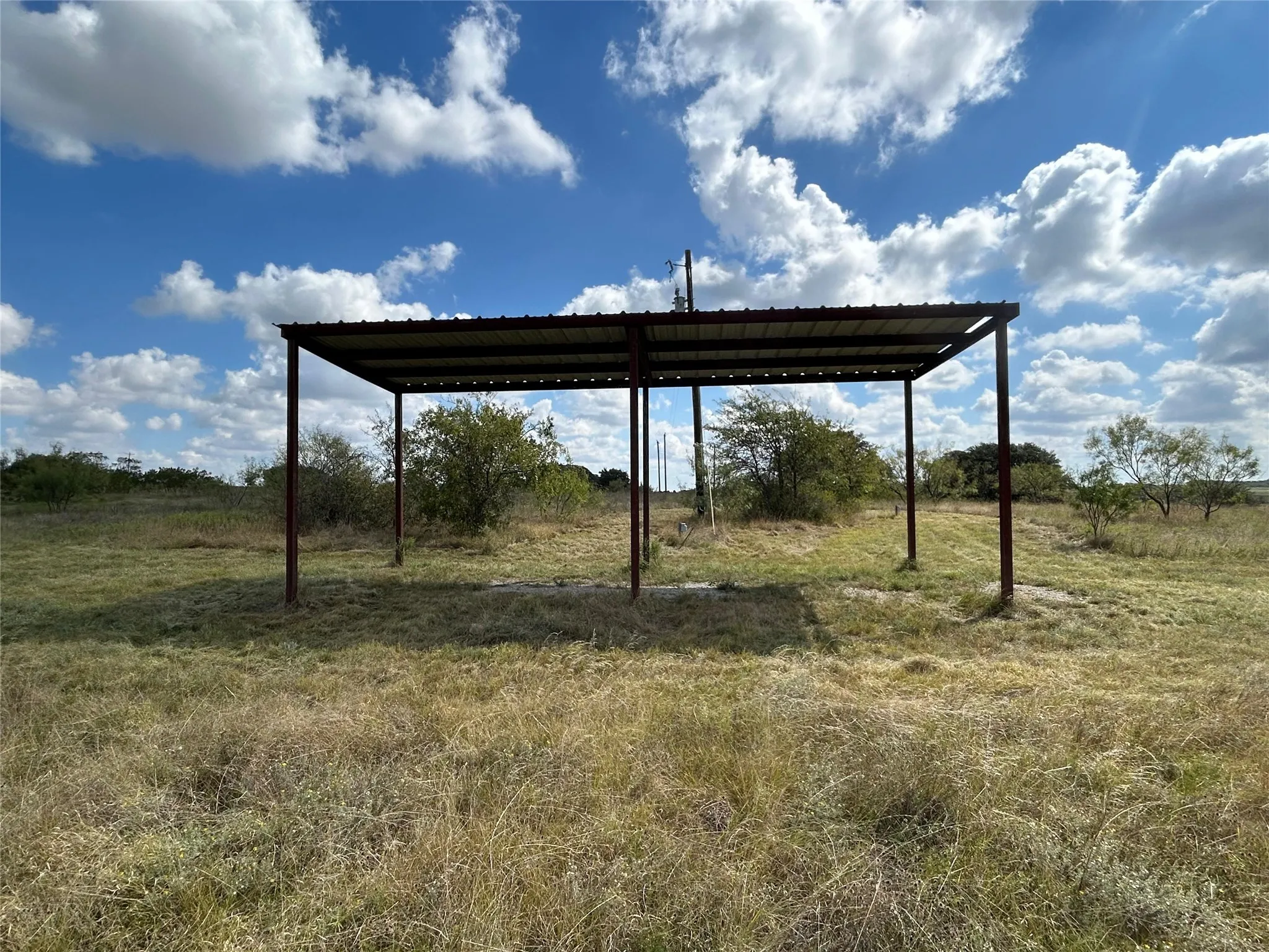 View of yard with a carport and a view of countryside