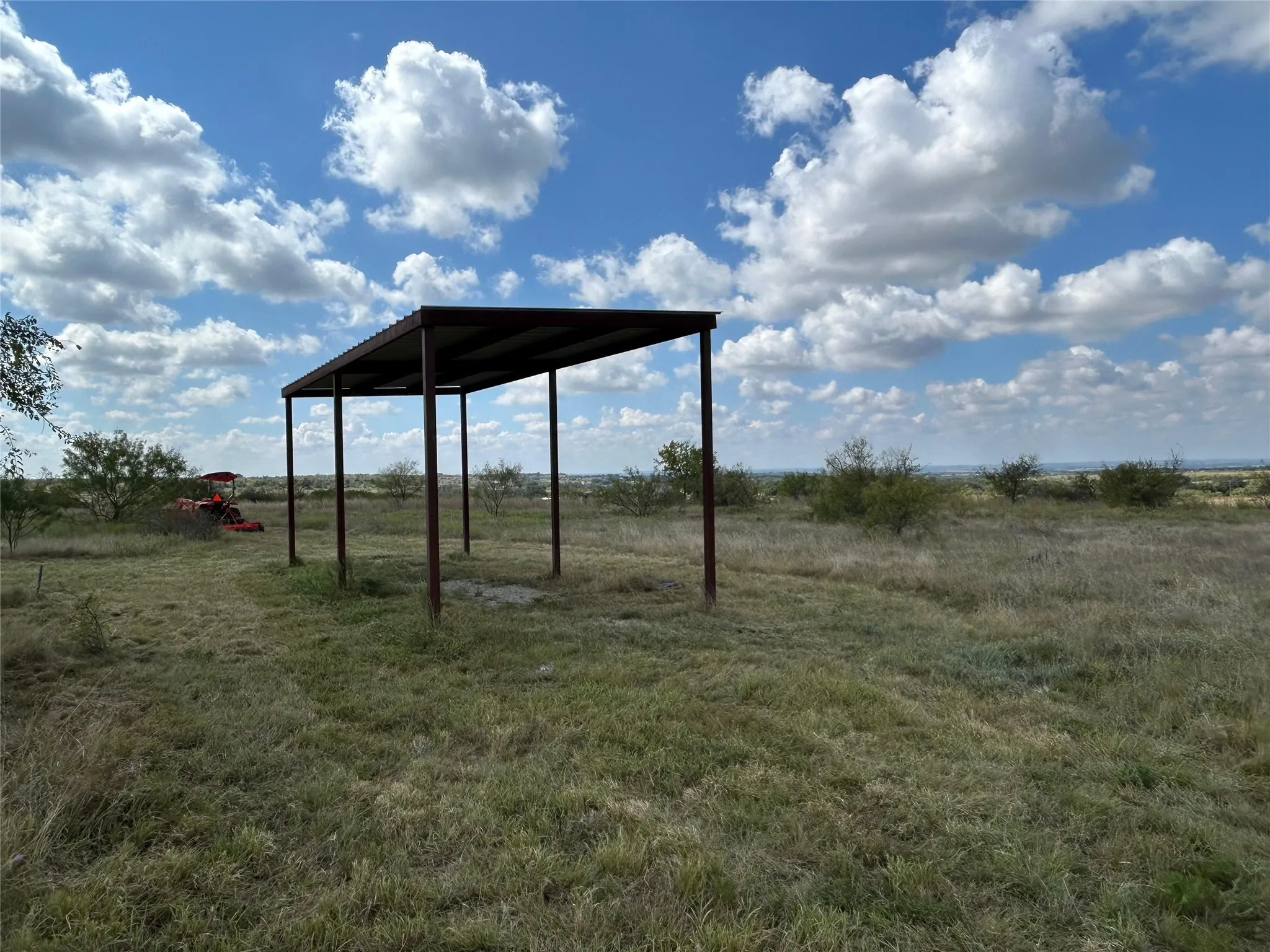 View of yard featuring a view of countryside and a carport