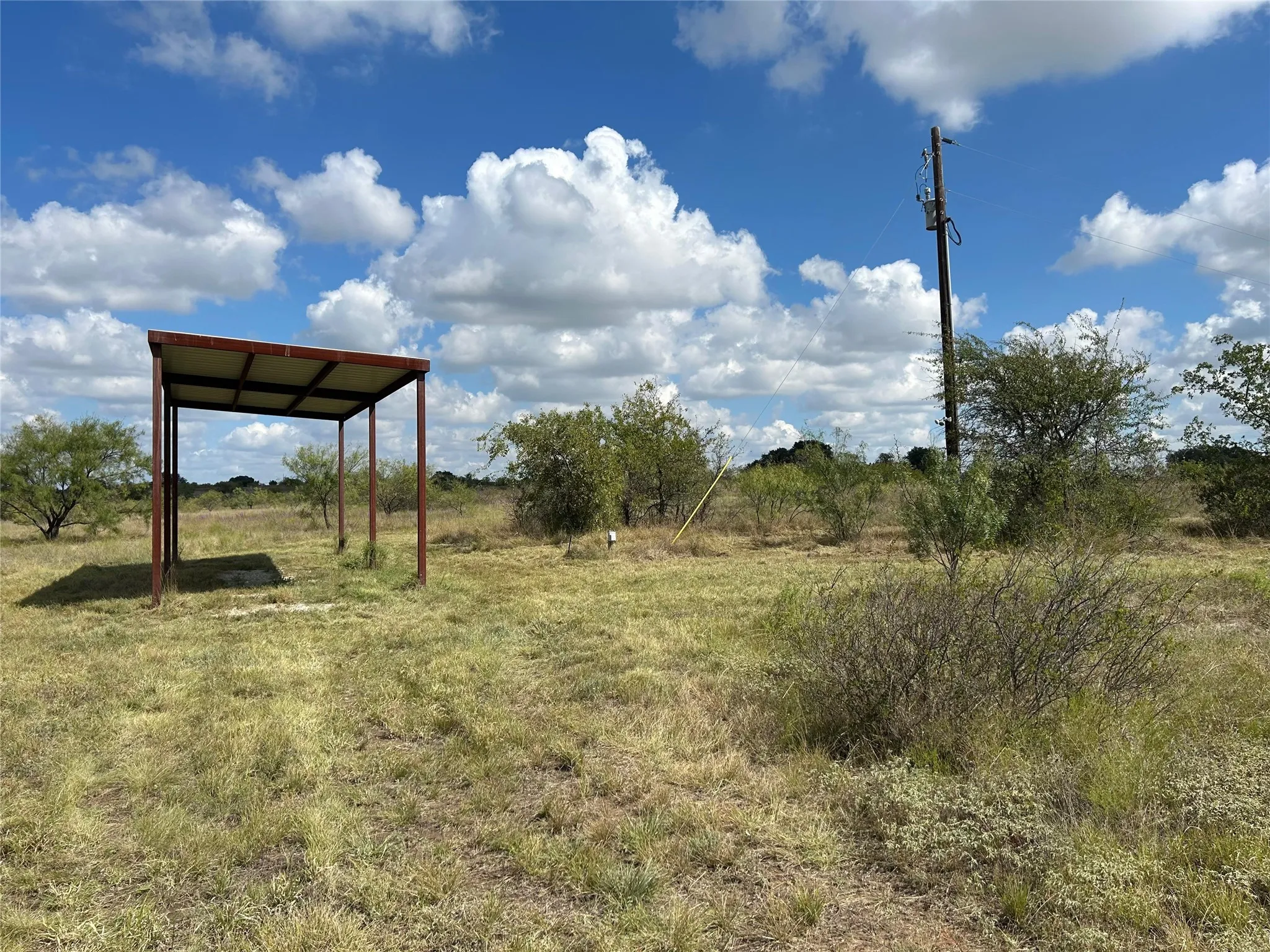 View of yard featuring a carport and a view of rural / pastoral area