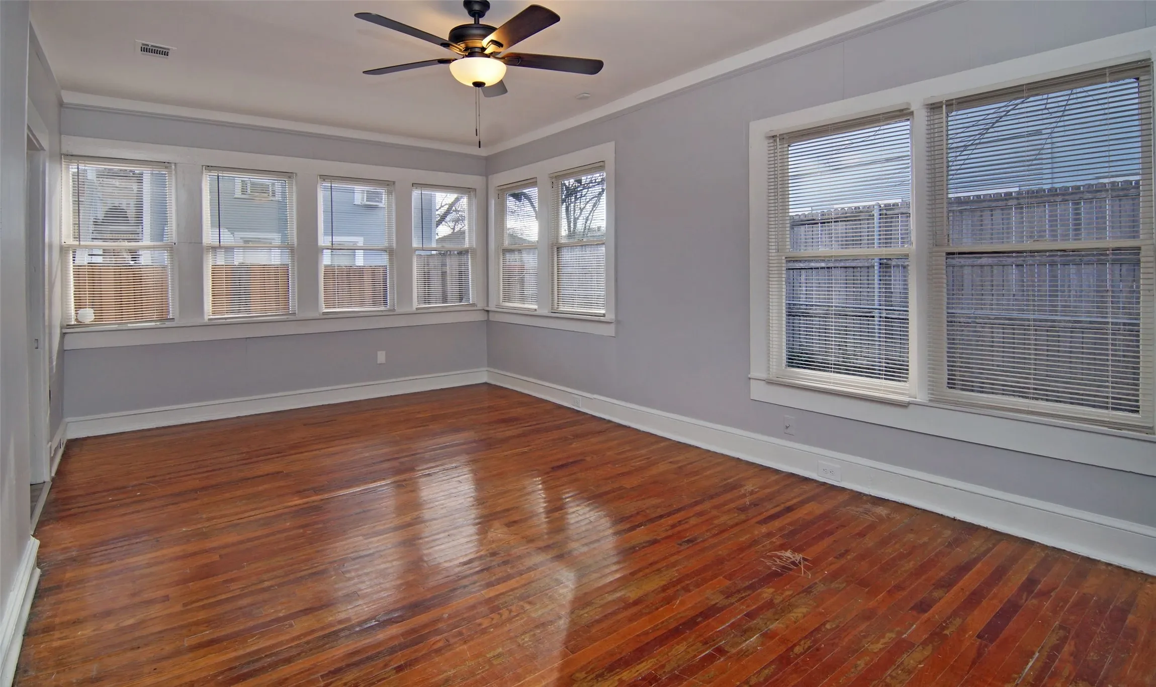 Primary bedroom. Lots of natural light, natural wood floors,