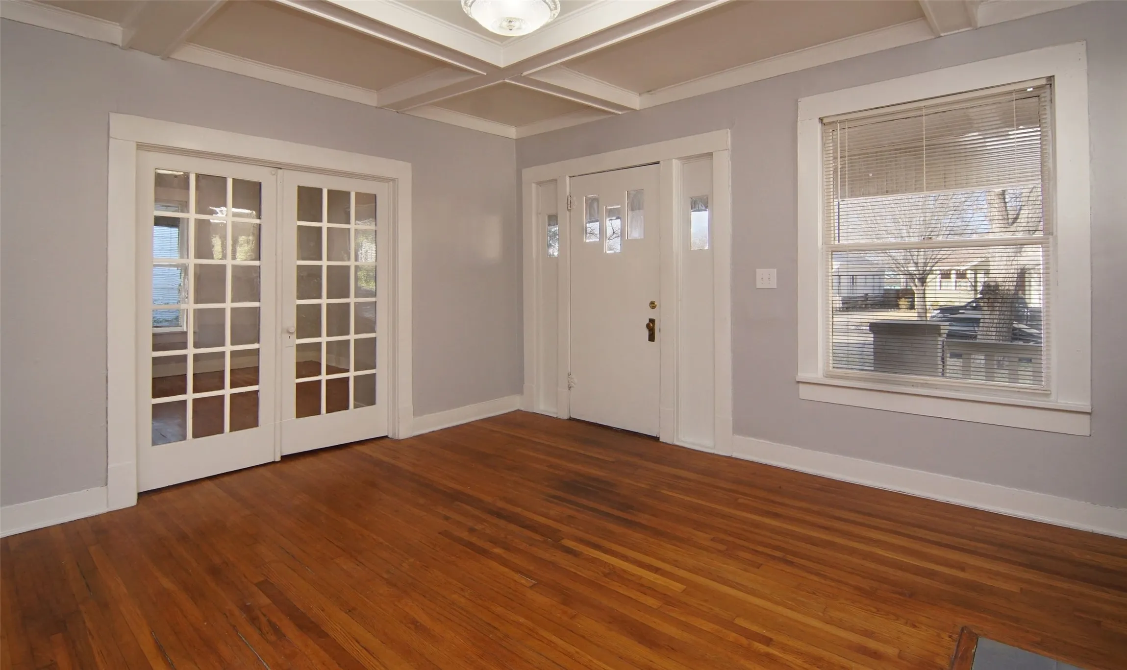 View 2 of the living room, french doors to enter bedroom 3 or office space