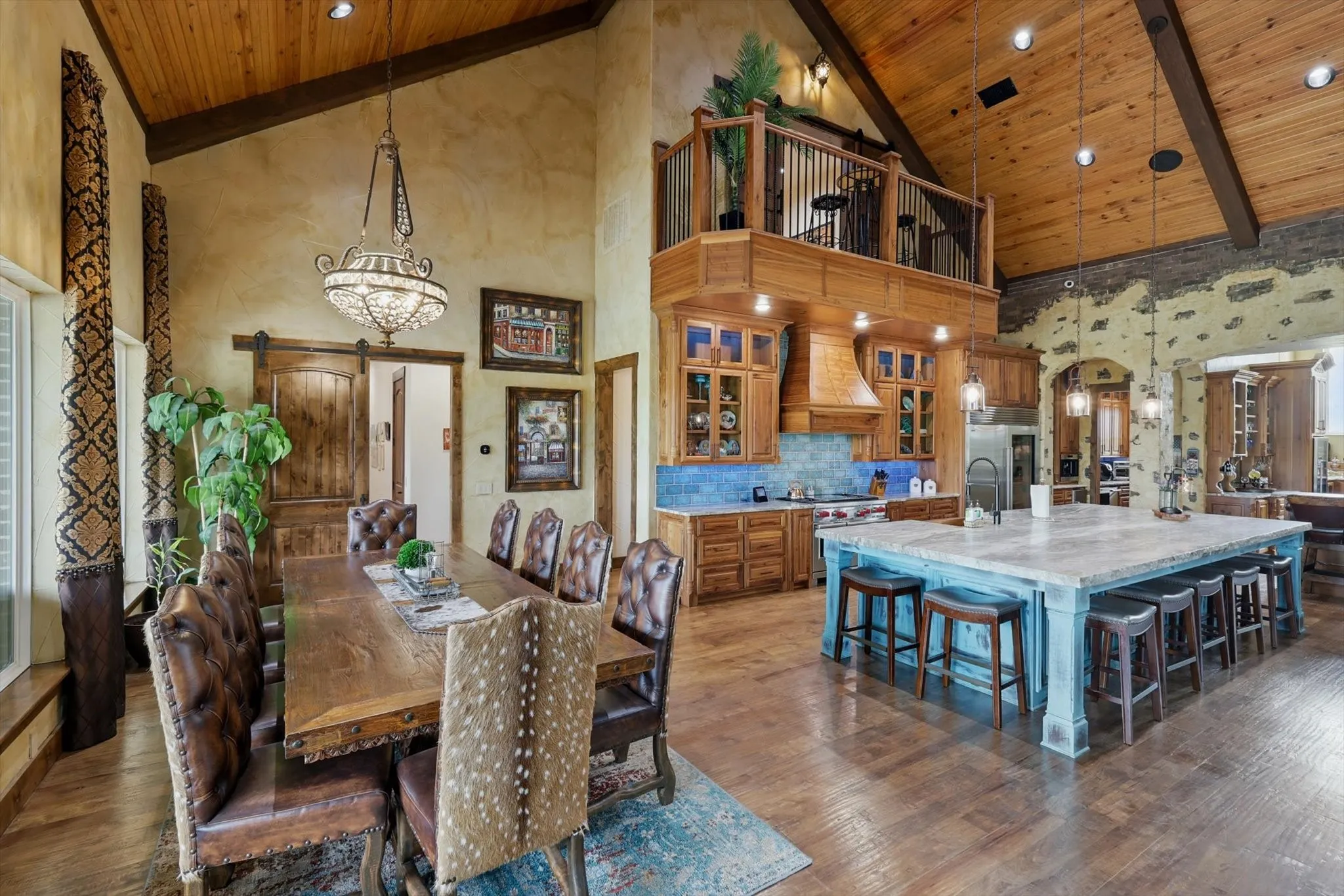 Dining space with a high wood beamed ceiling, arched walkways, dark wood-style flooring, a barn door, and a chandelier