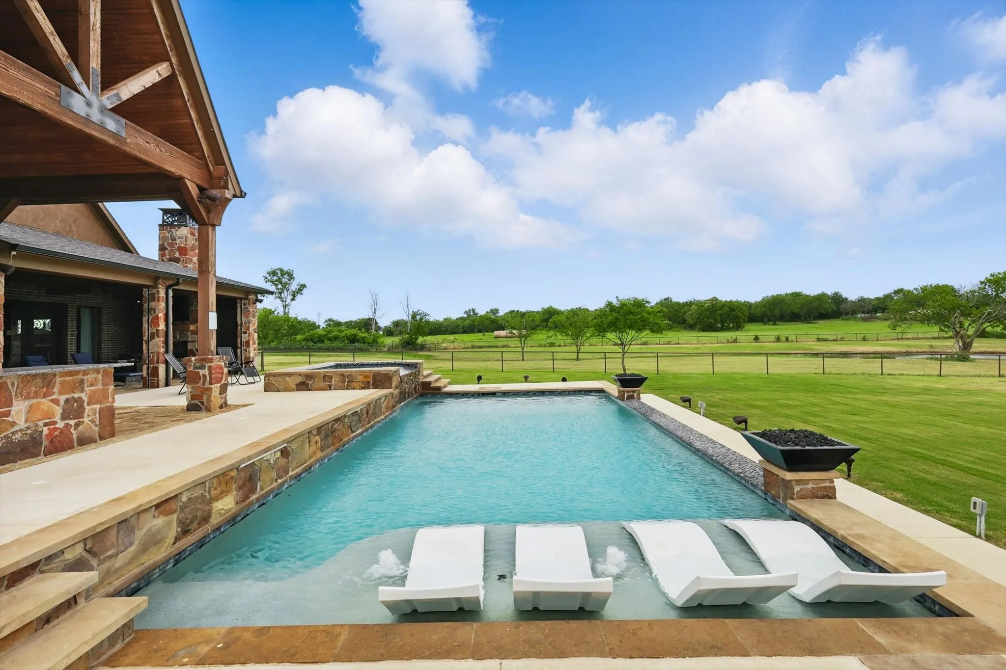 Swimming pool with a patio and a fenced backyard